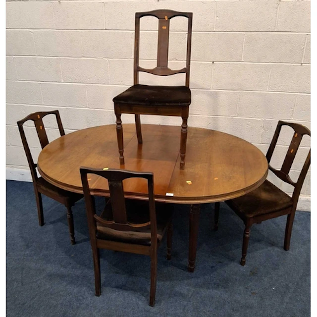 AN EXTENDING DINING TABLE, with a single fold out leaf, rais...