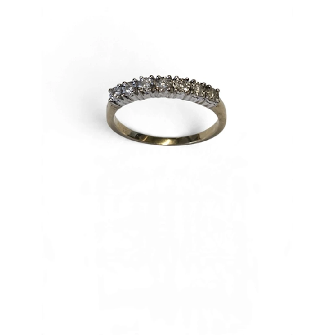 A lovely 18-carat gold nine-stone diamond cluster ring, the ...