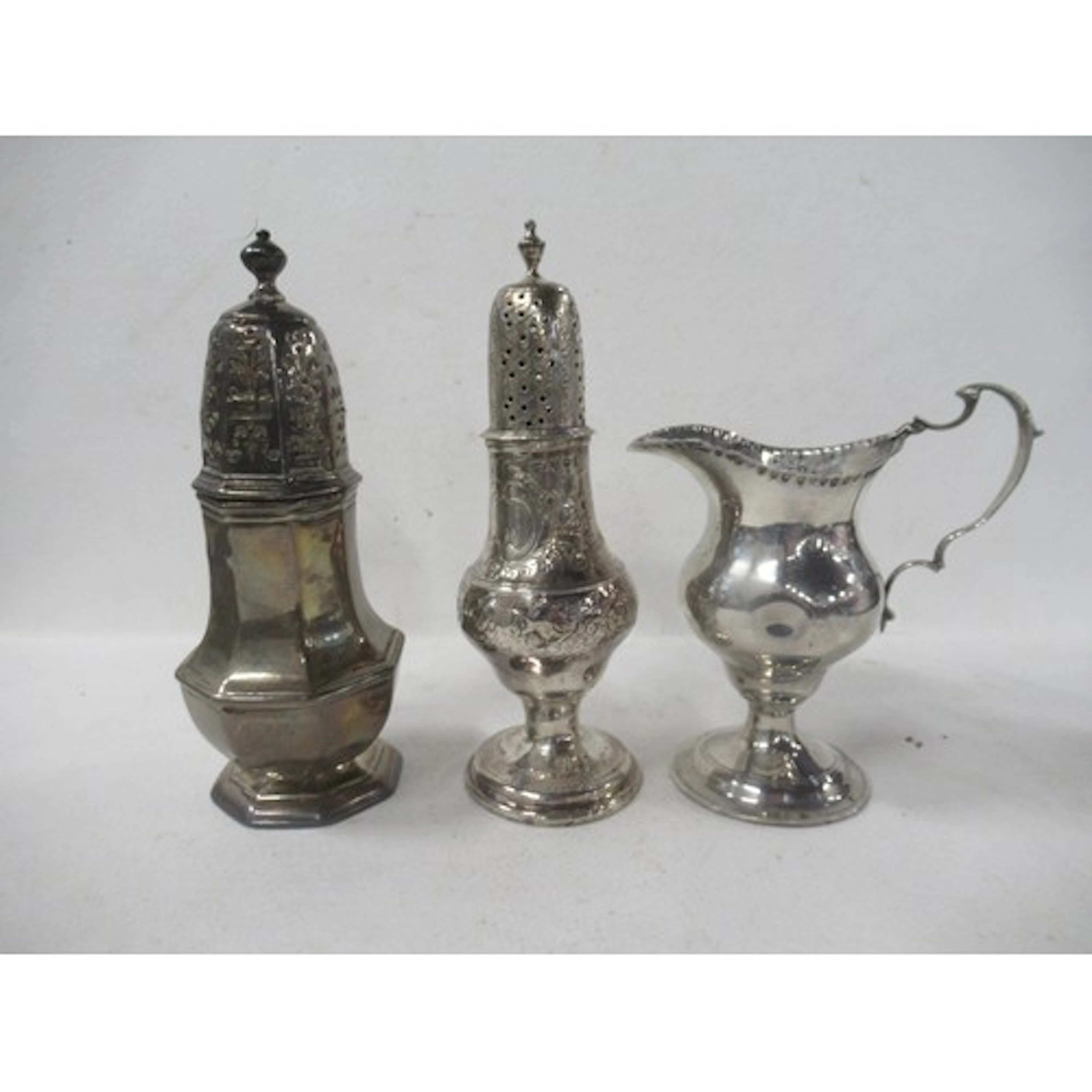 A silver sugar caster, together with a silver cream jug, wei...