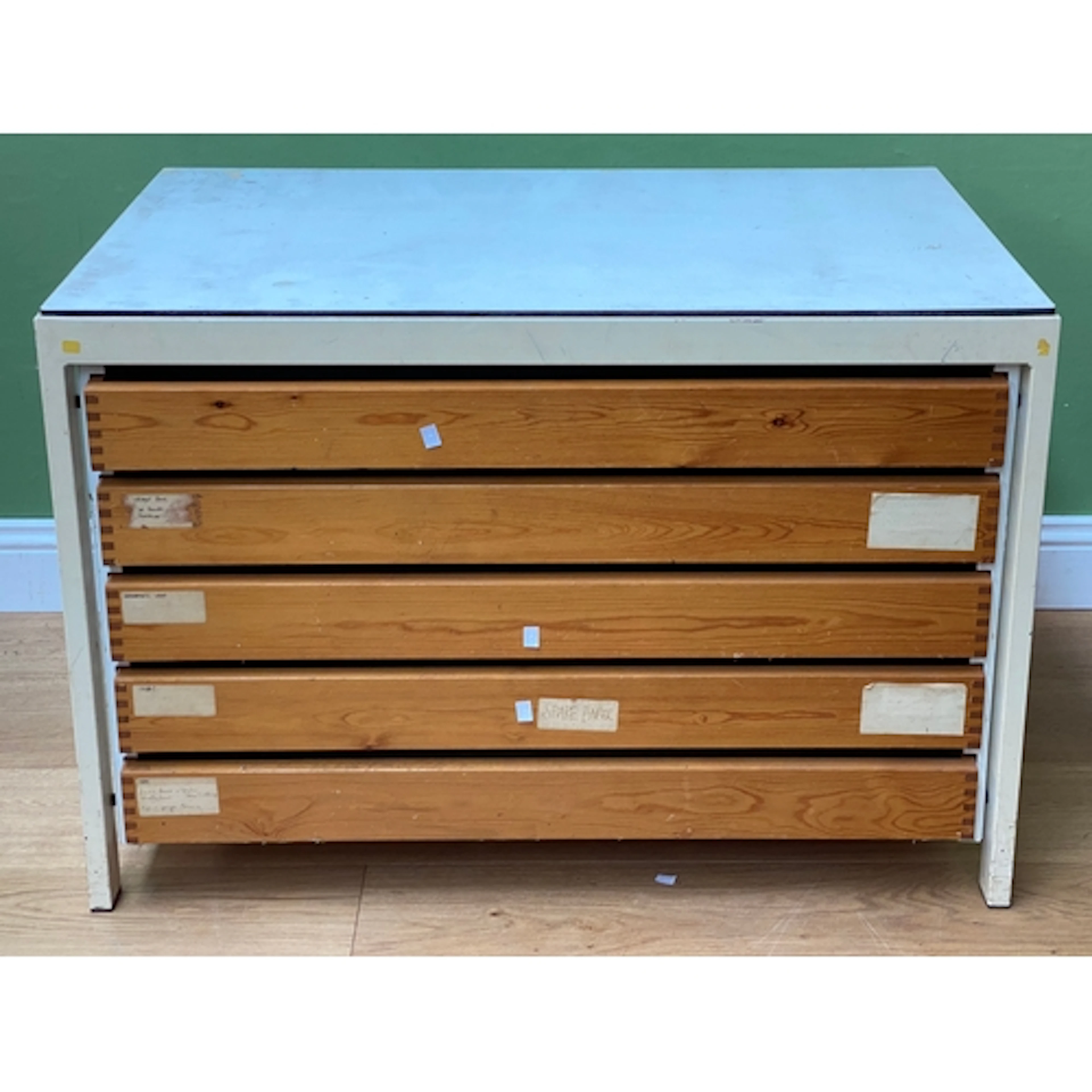 A metal industrial plan chest with formica top and five pine...