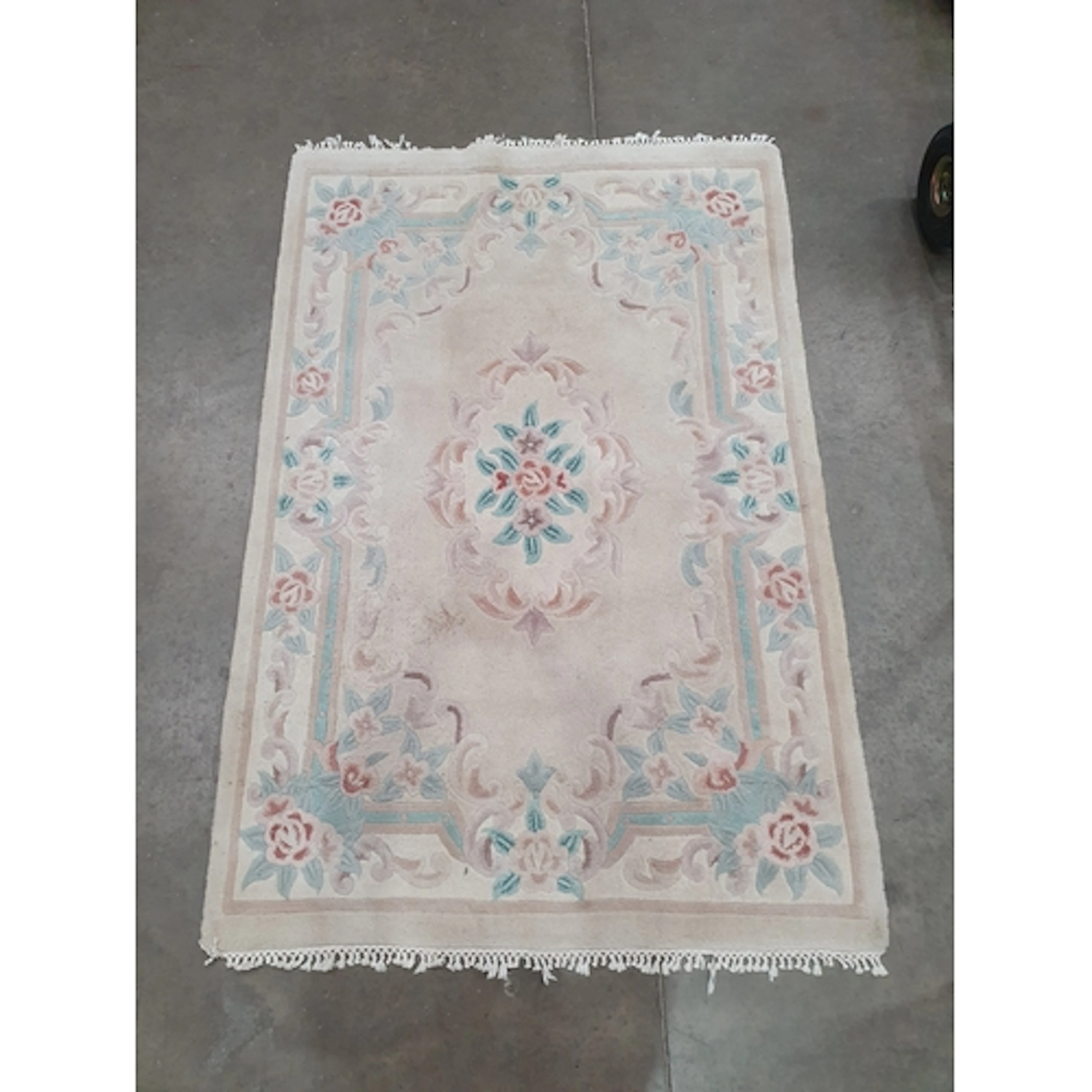 A Chinese style Rug on beige ground with floral border and c...