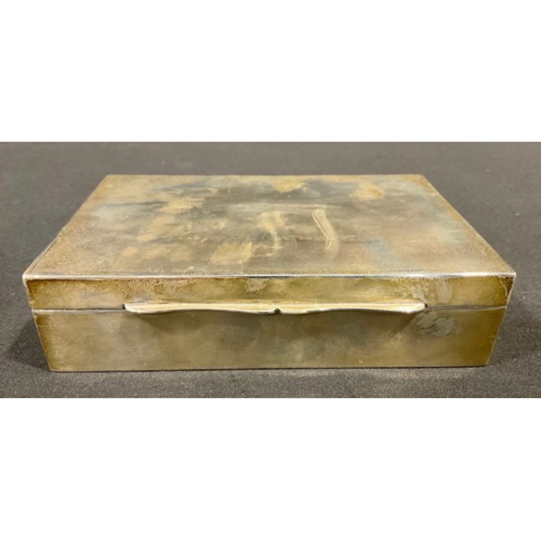 A George VI silver cigarette box, engine turned hinged cover...