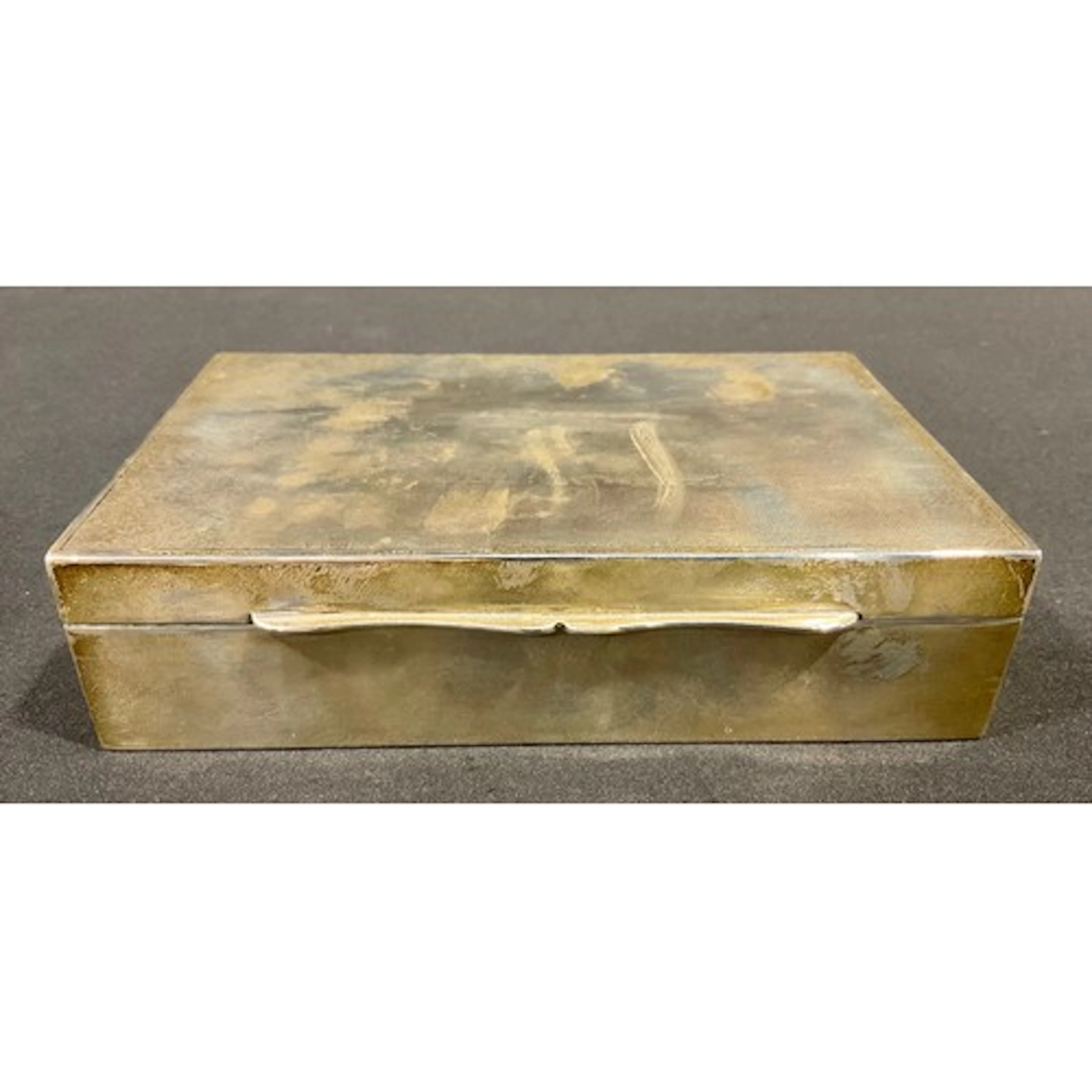 A George VI silver cigarette box, engine turned hinged cover...