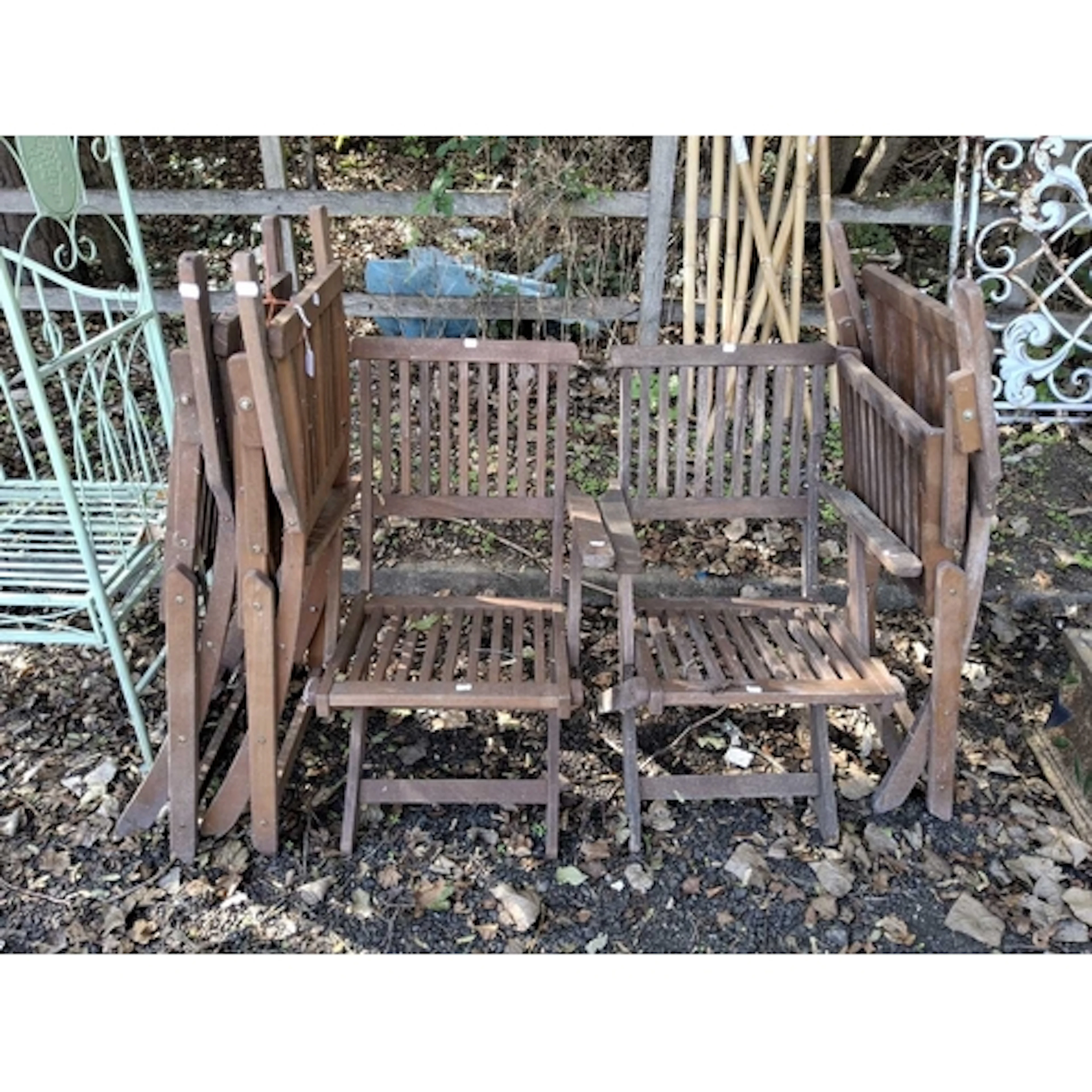 A SET OF FIVE FOLDING HARDWOOD GARDEN CHAIRS one chair dama...