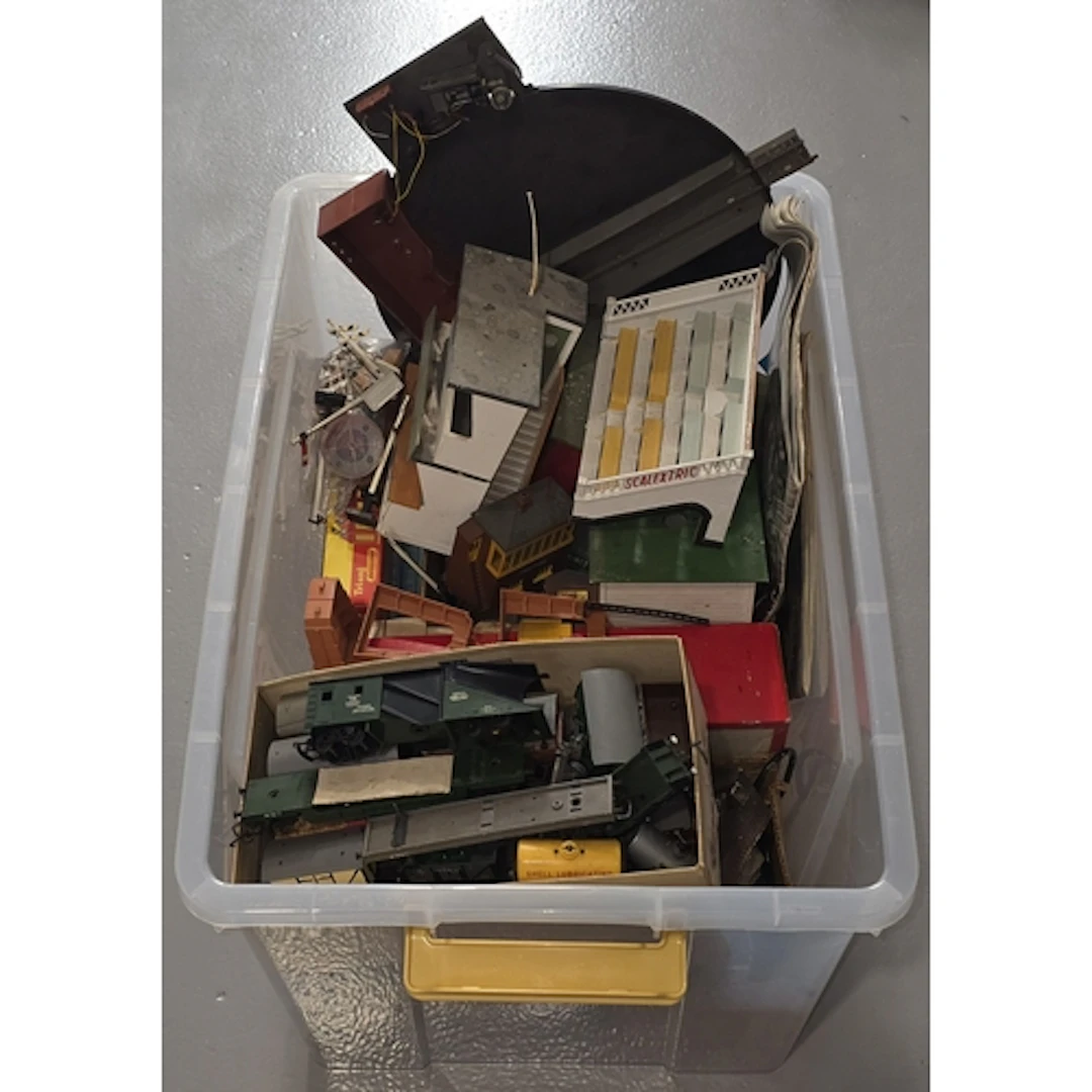 A large tub containing mostly model railway scenery and trac...
