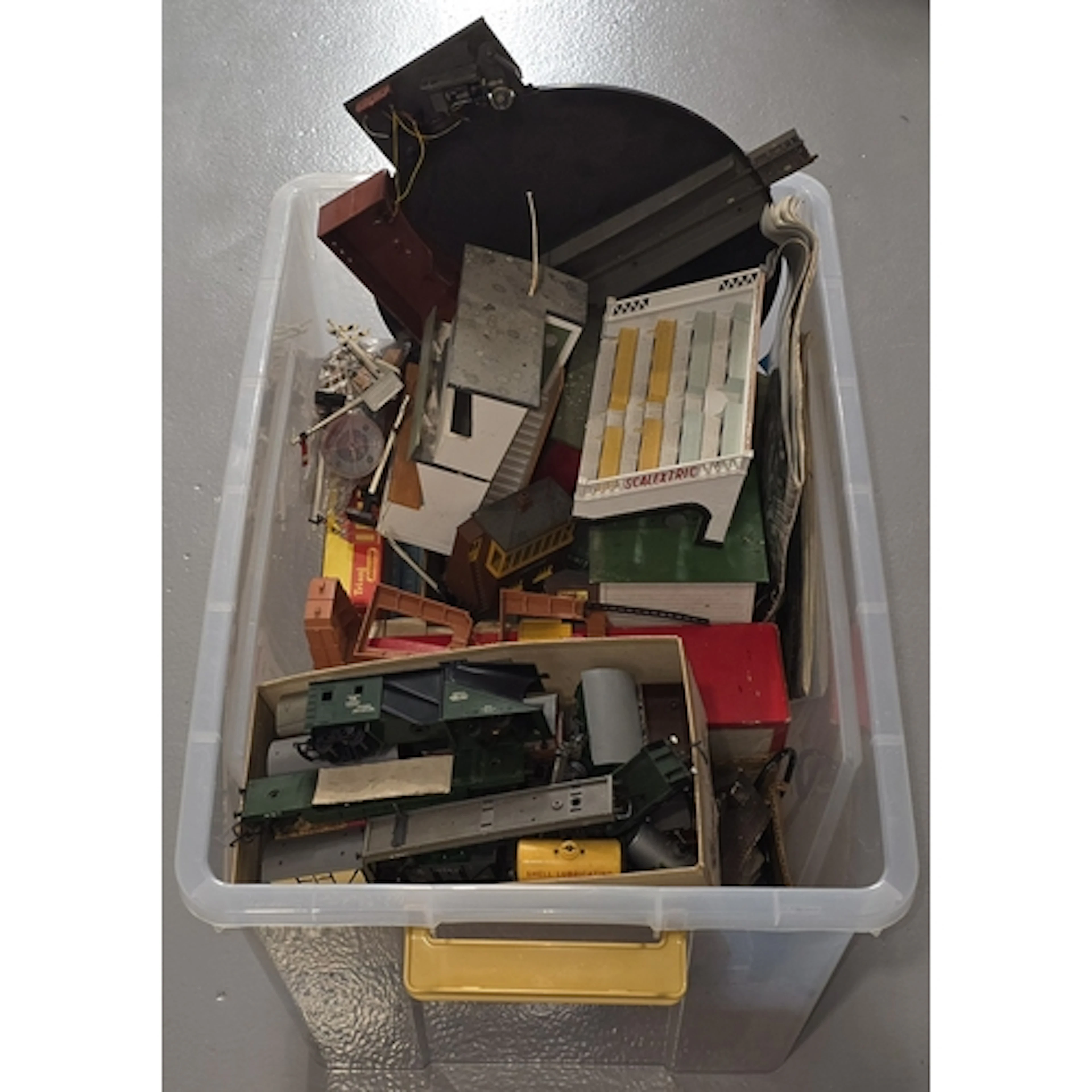 A large tub containing mostly model railway scenery and trac...