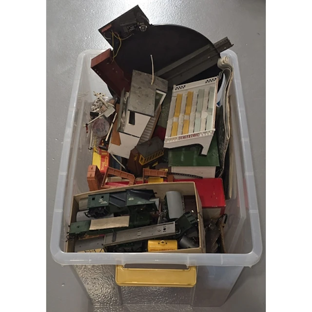 A large tub containing mostly model railway scenery and trac...