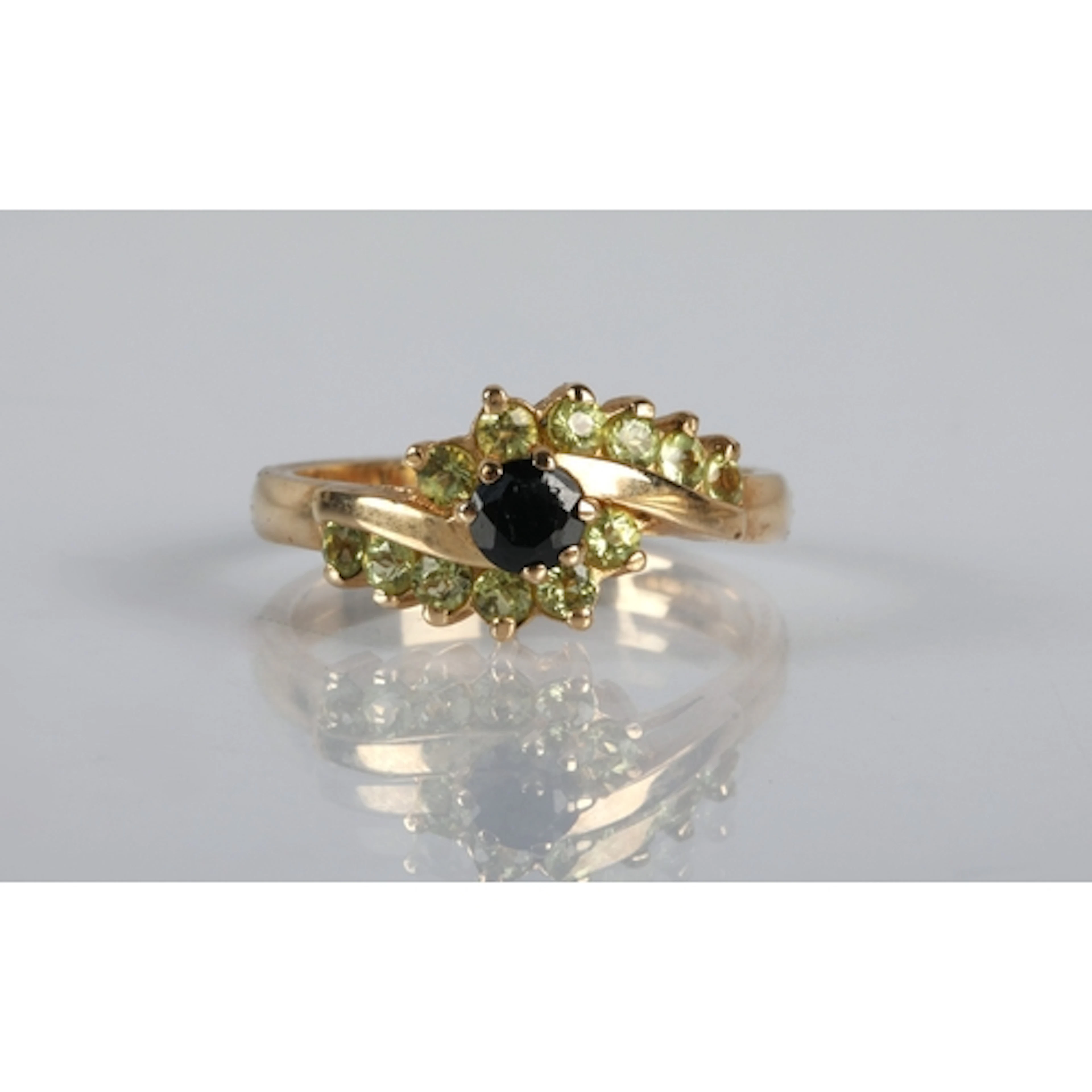 Ladies gold ring, with gems set in a twist form, ring size O...