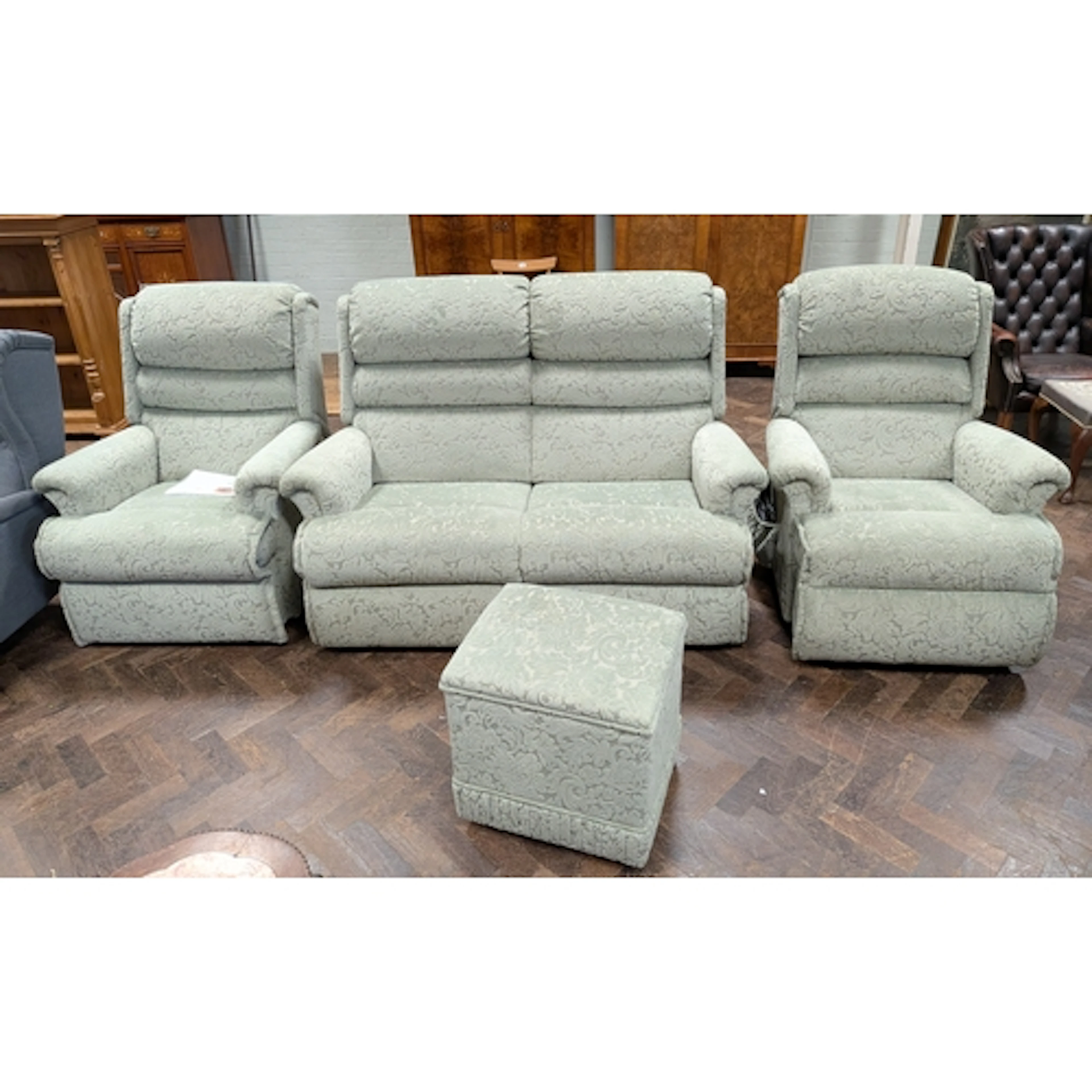 A Sherborne two seater settee three piece suite in green emb...