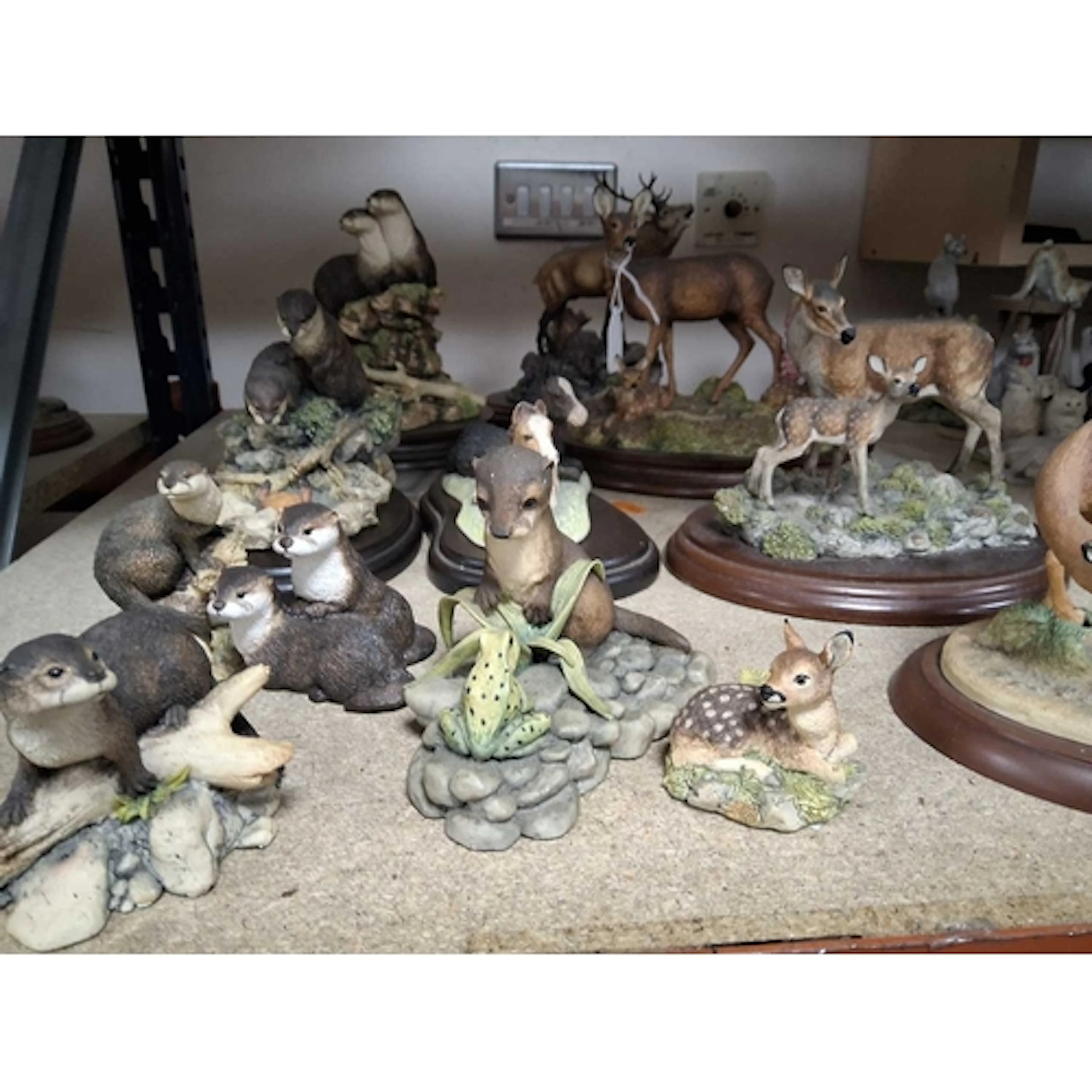 A GROUP OF BORDER FINE ARTS SCULPTURES featuring various woo...