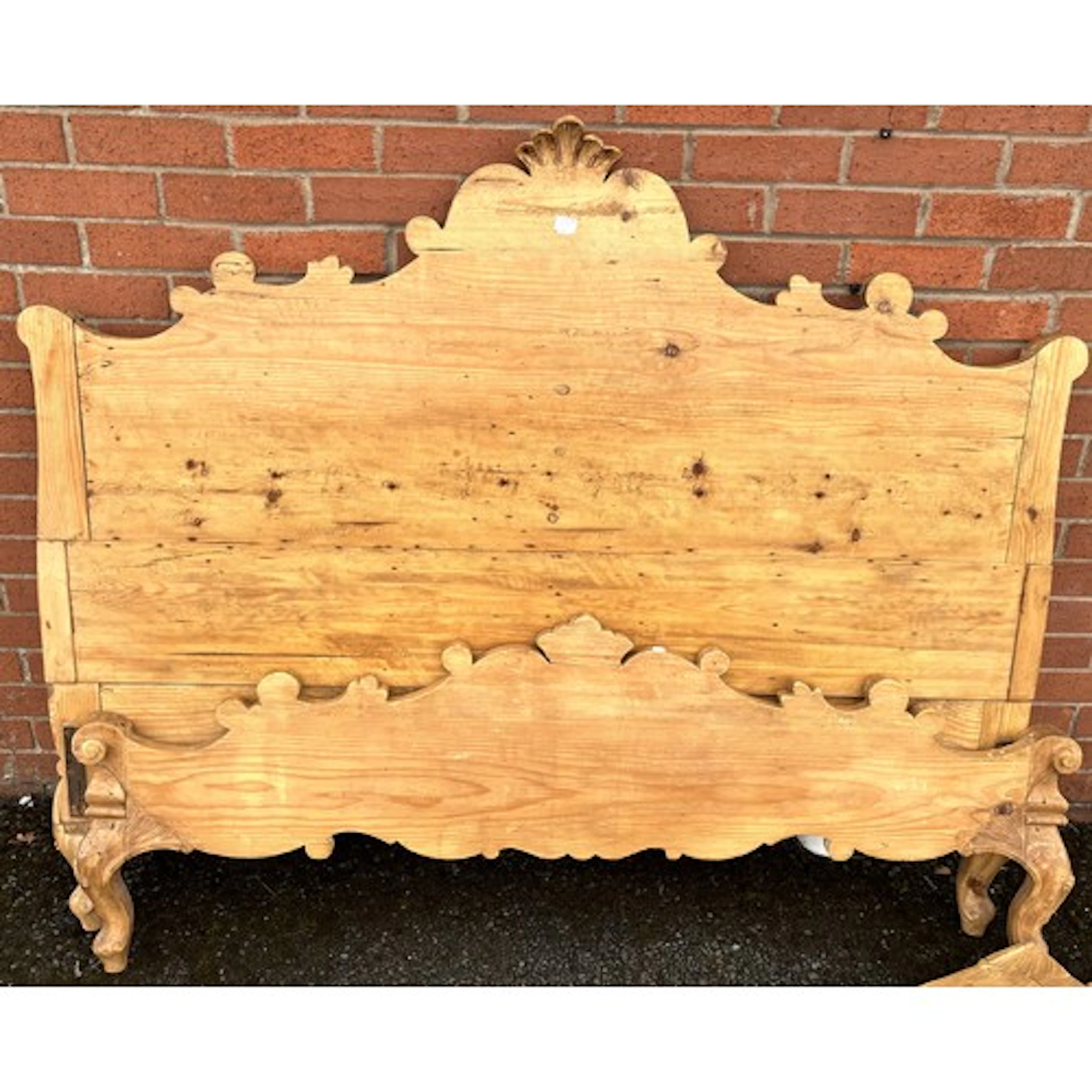 An antique pine double bed with carved decoration complete w...