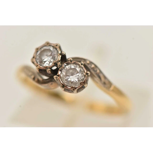 A YELLOW METAL TWO STONE DIAMOND RING, a toi et moi style ri...