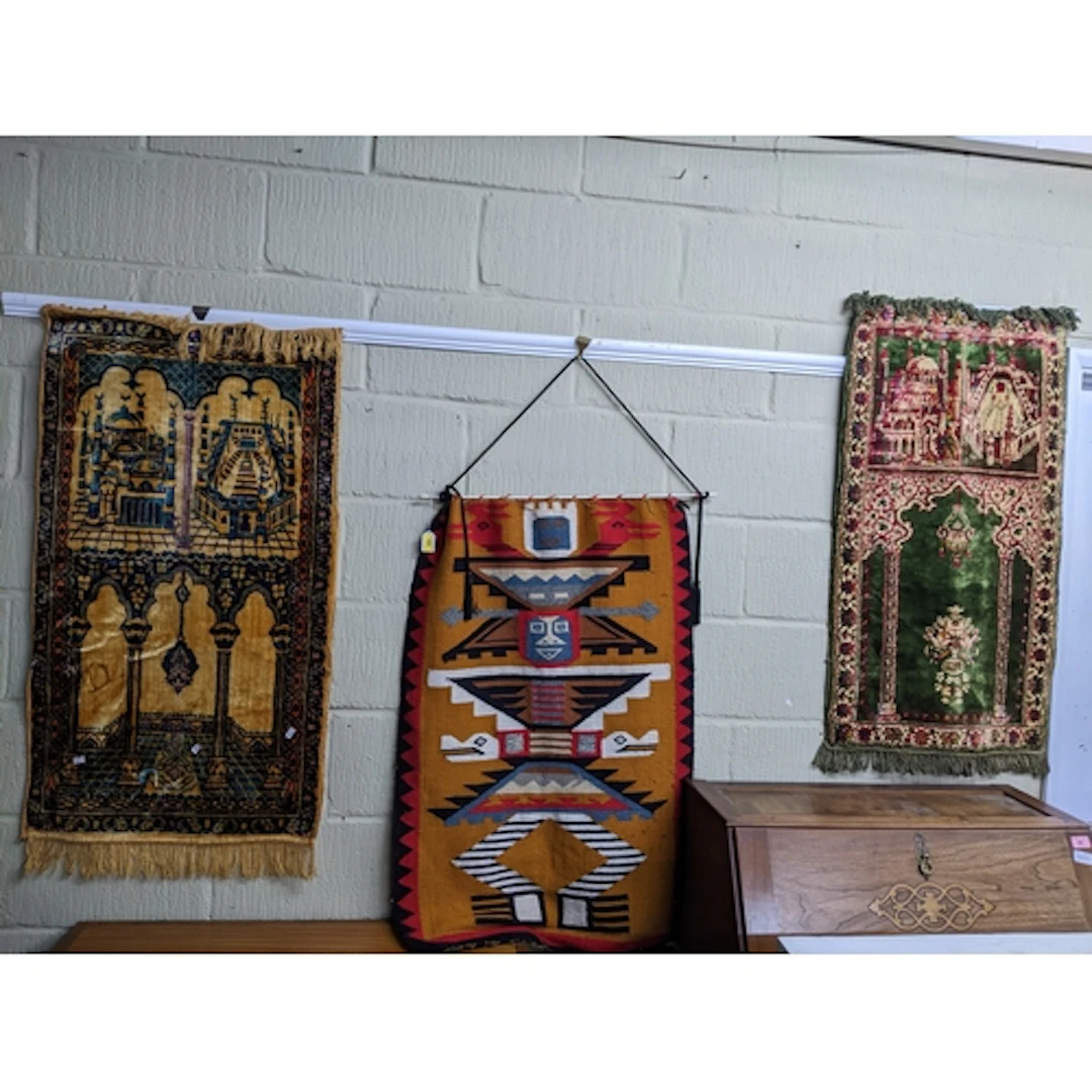 A group of three wall hangings to include two Turkish style ...