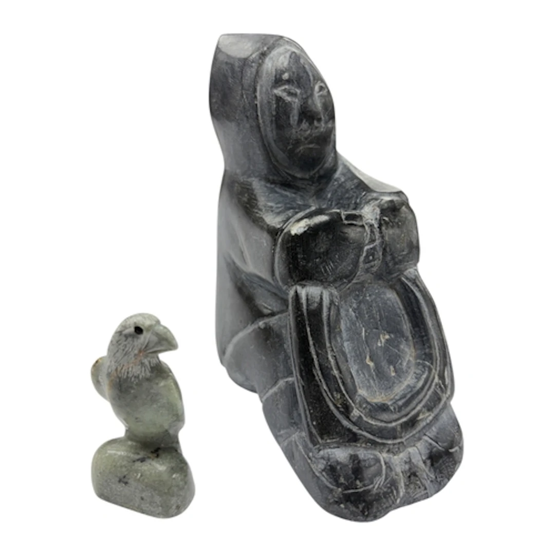 Two Inuit stone carvings of a seated figure and a falcon, la...
