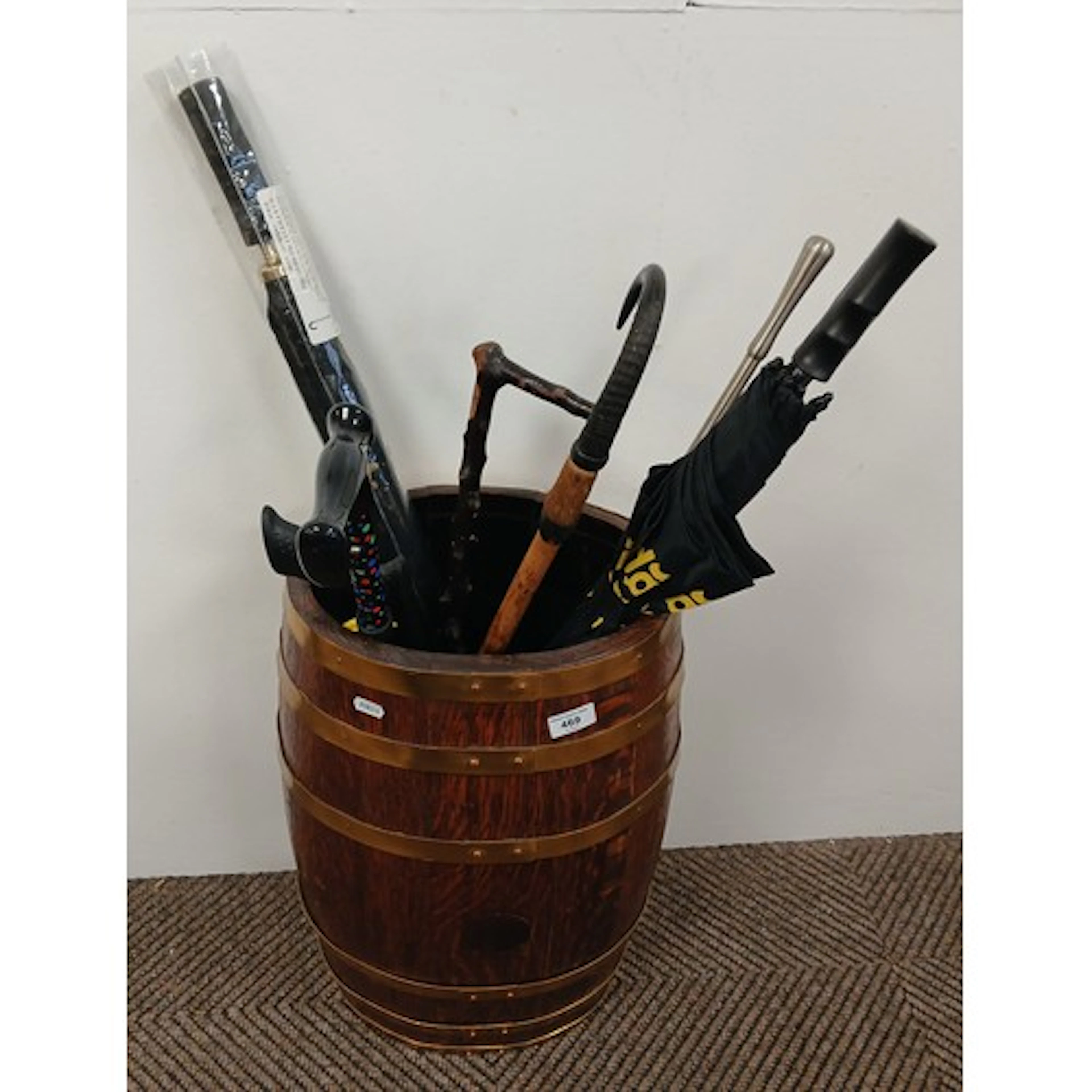 Oak brass bound barrel stick stand and contents.
