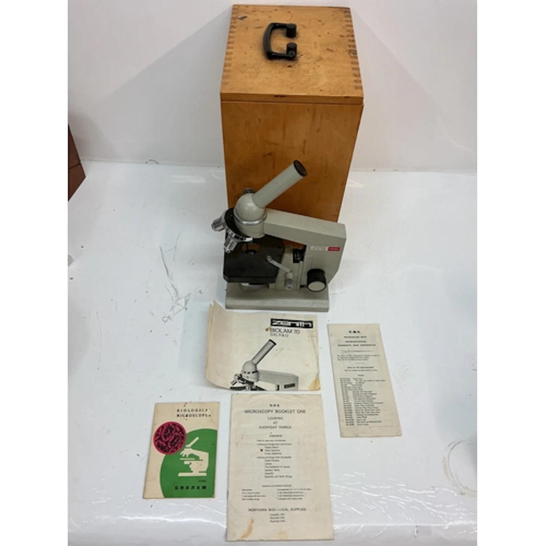 A boxed Nomo Biolam microscope