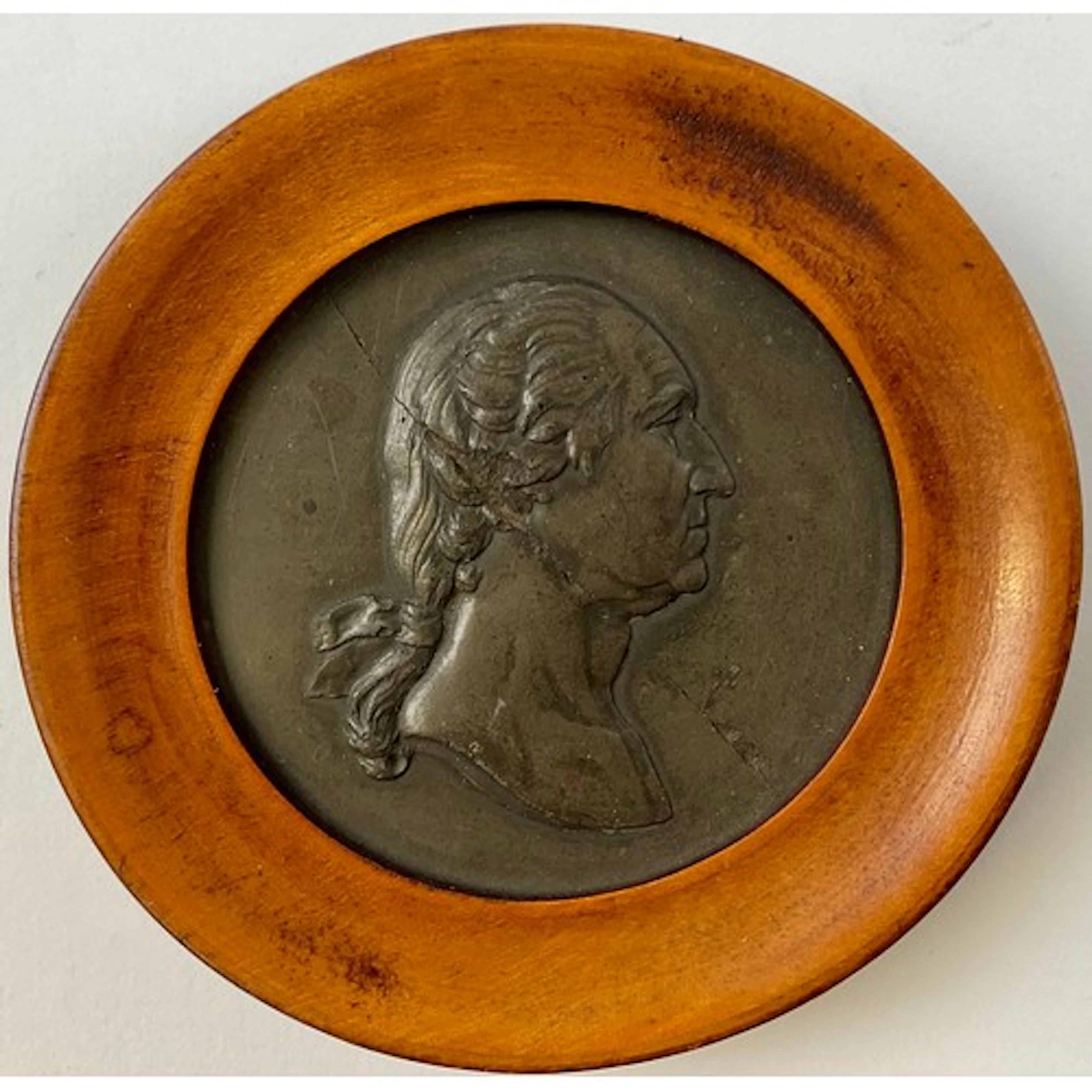 A 19th century black basalt portrait miniature, cast with a ...