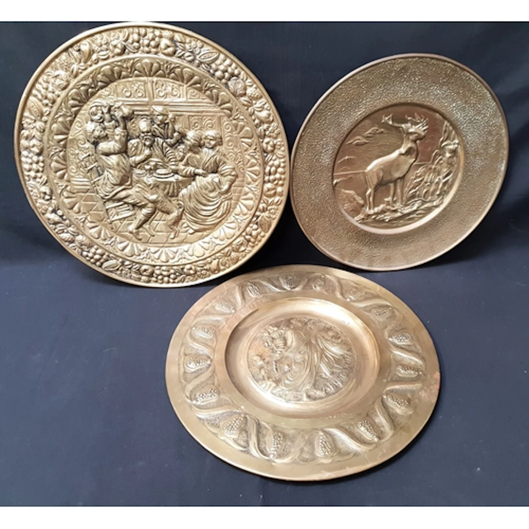 THREE RELIEF BRASS WALL CHARGERS one depicting Abundantia to...