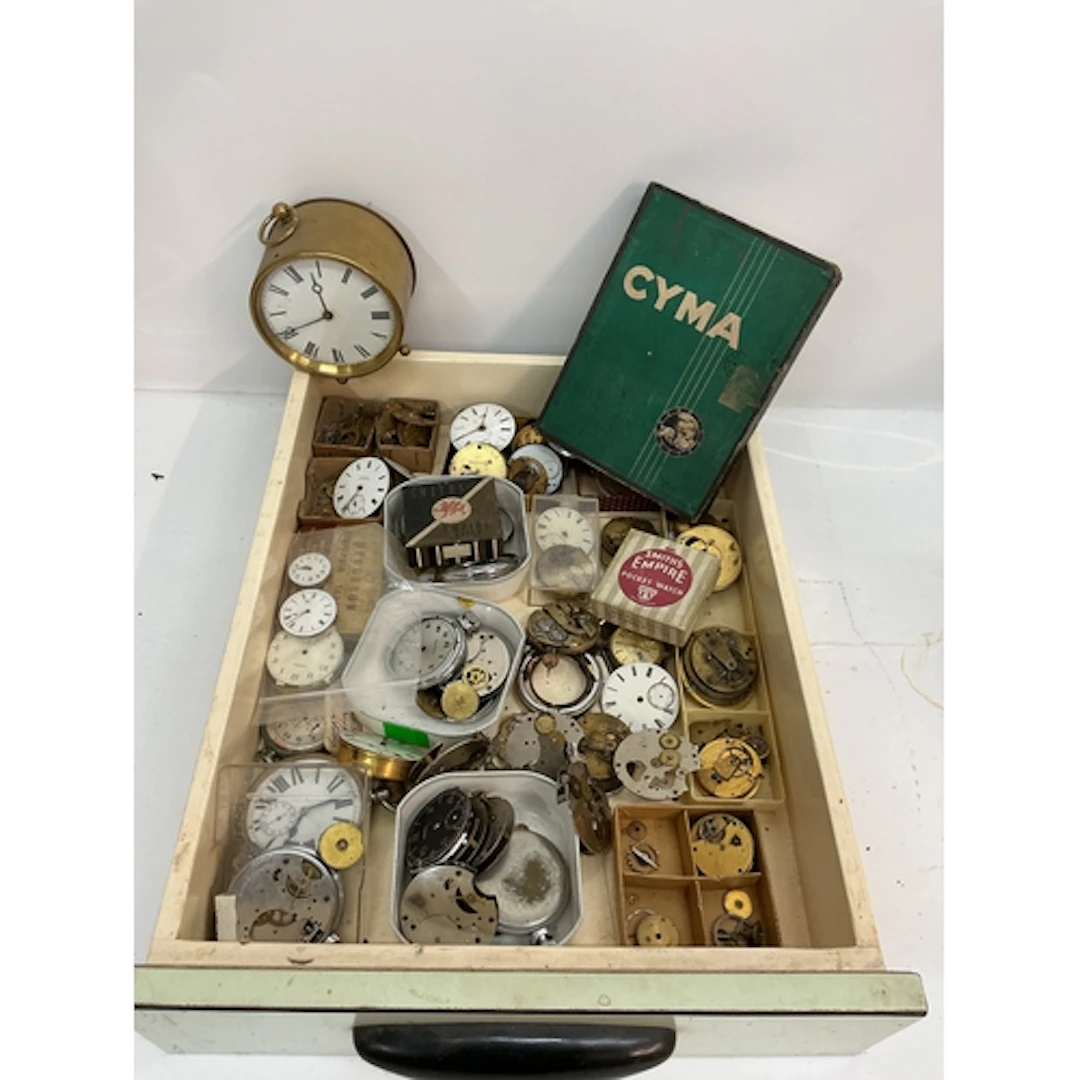 A tray containing vintage pocket watch movements