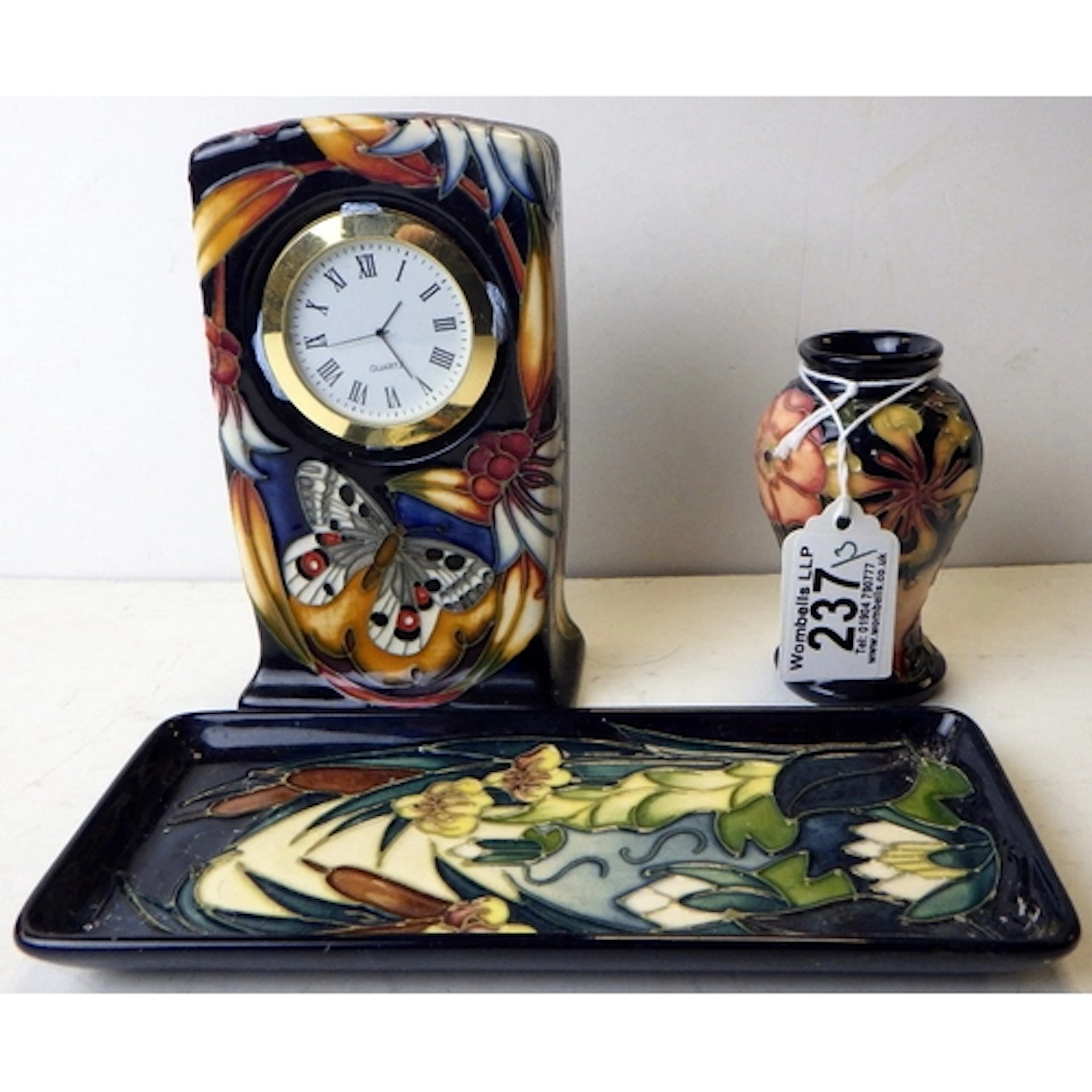A Moorcroft clock, tray & miniature vase (3)