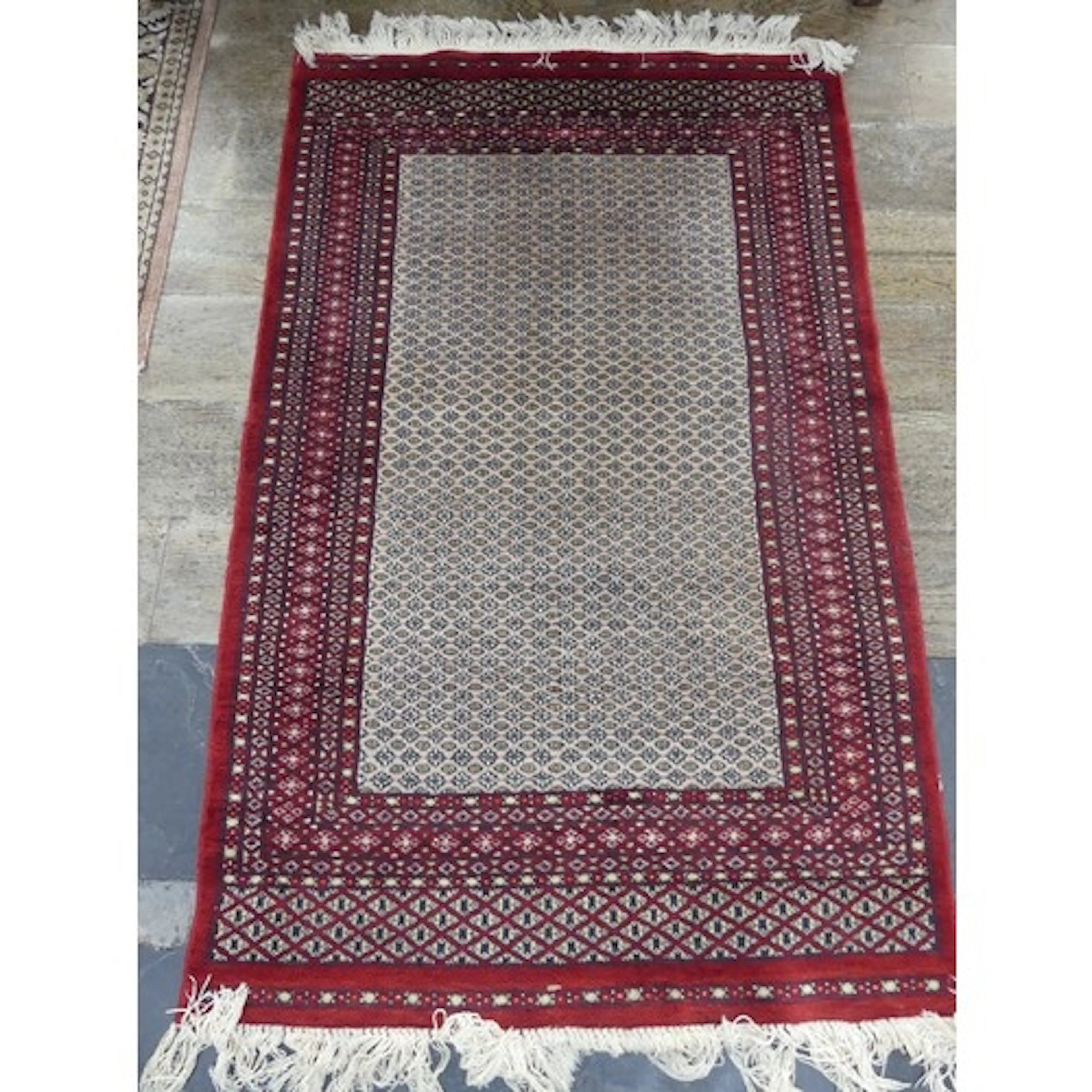 Tribal Rugs; a finely knotted red and cream ground Afghan ru...