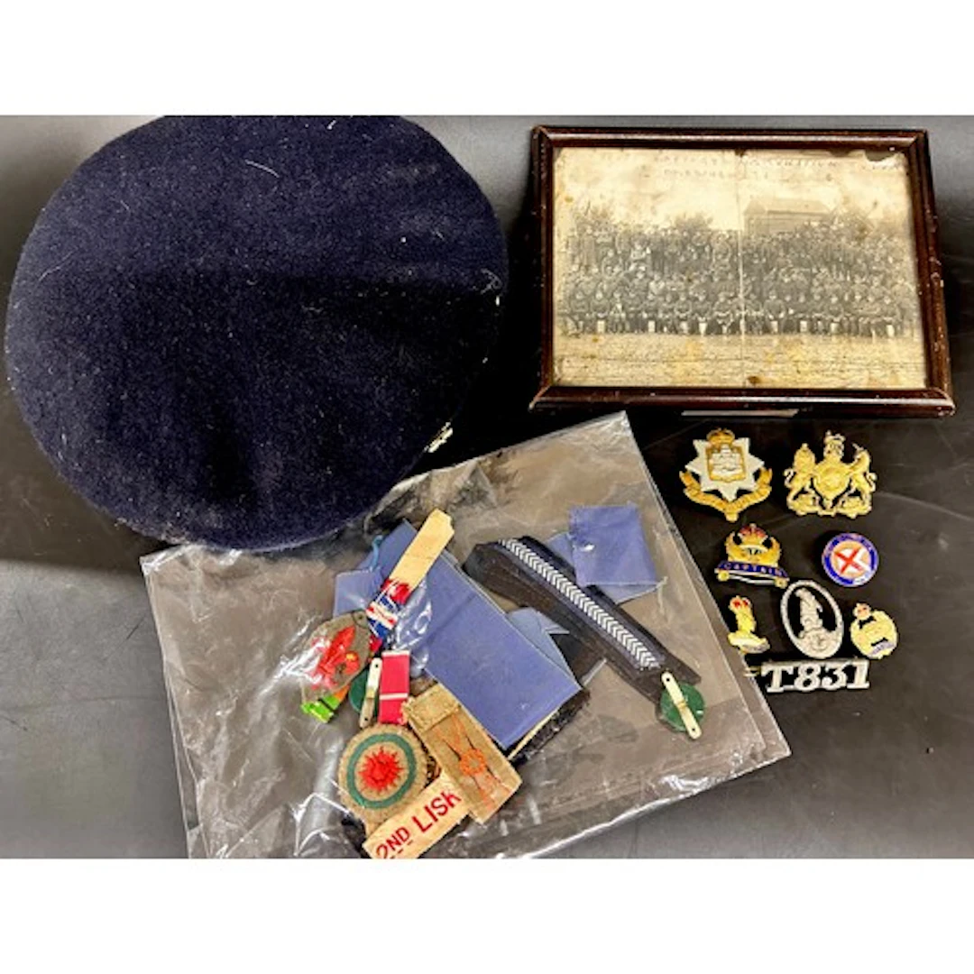 Military badges, uniform patches, a photograph and a beret