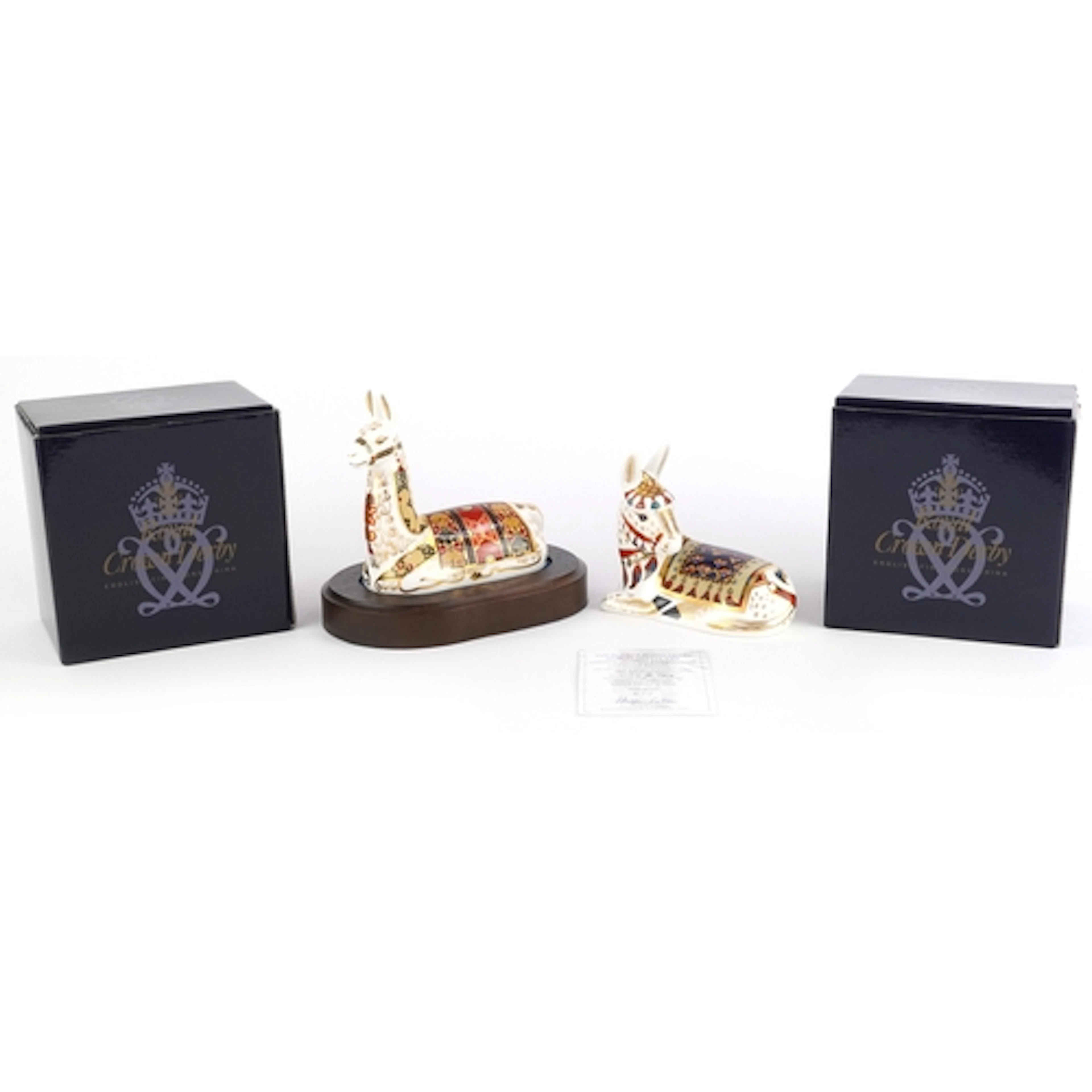 Two Royal Crown Derby paperweights comprising Thistle Donkey...