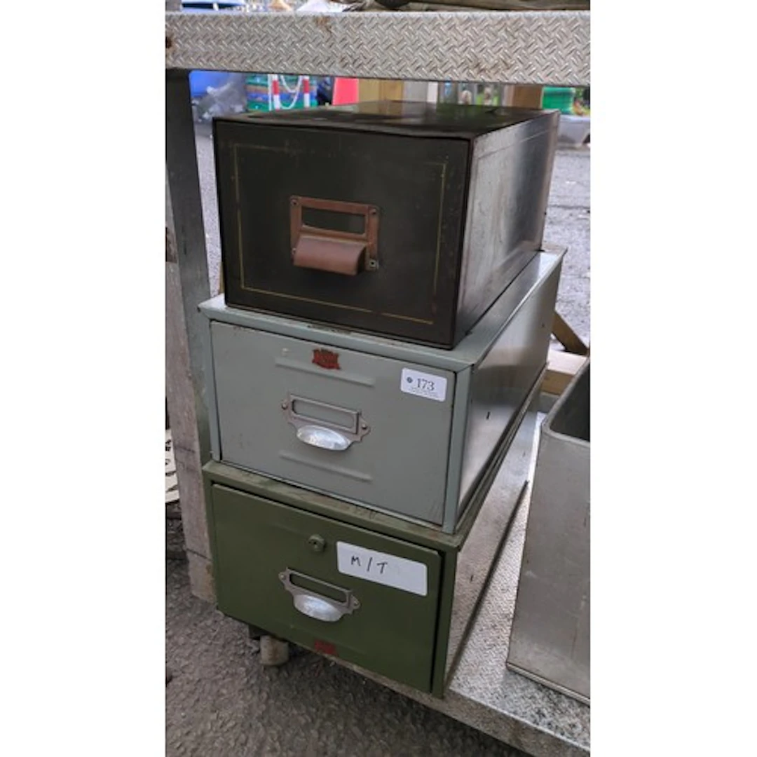 A group of painted metal index-card filing drawers in black