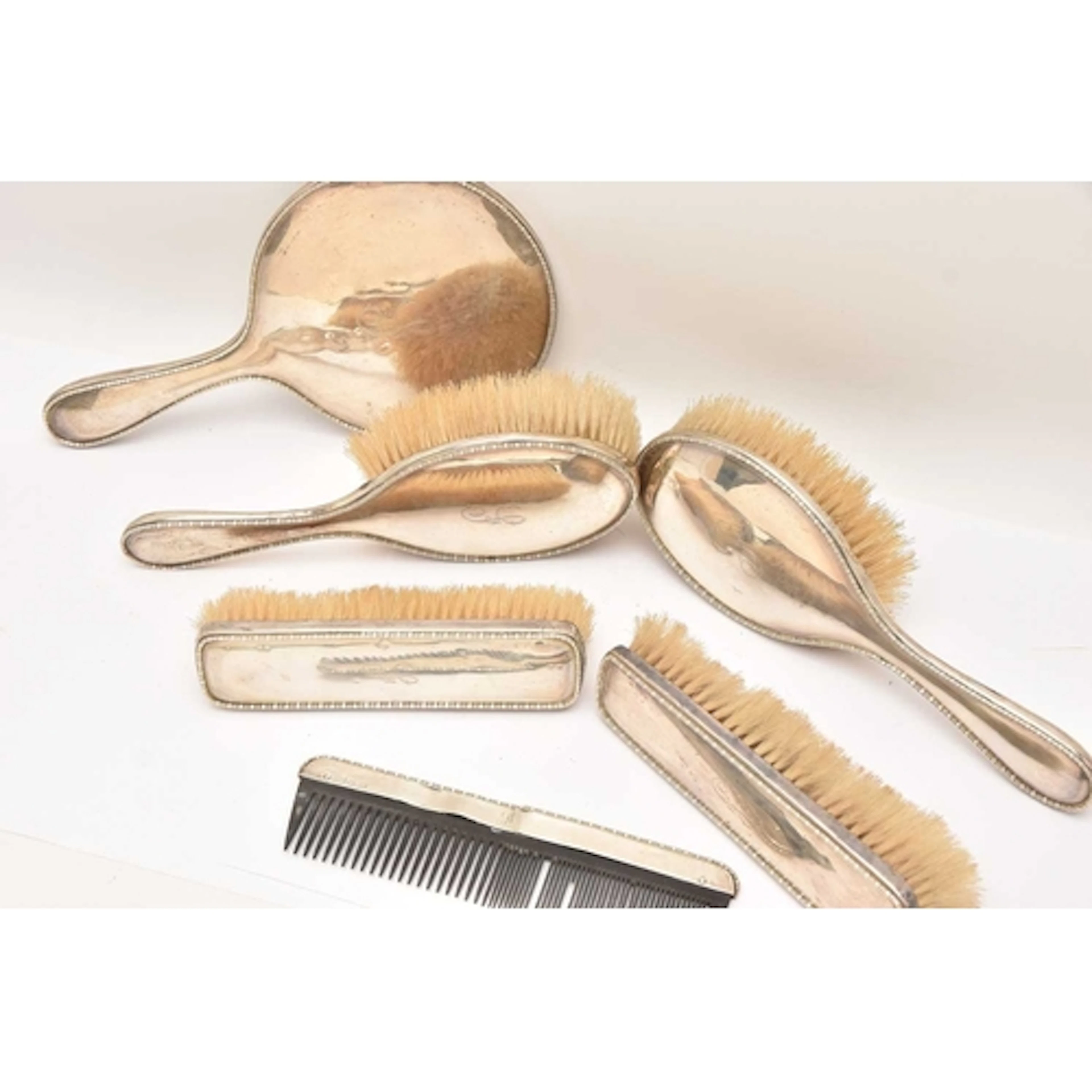A SILVER SIX PIECE DRESSING TABLE SET, comprising of a hand ...