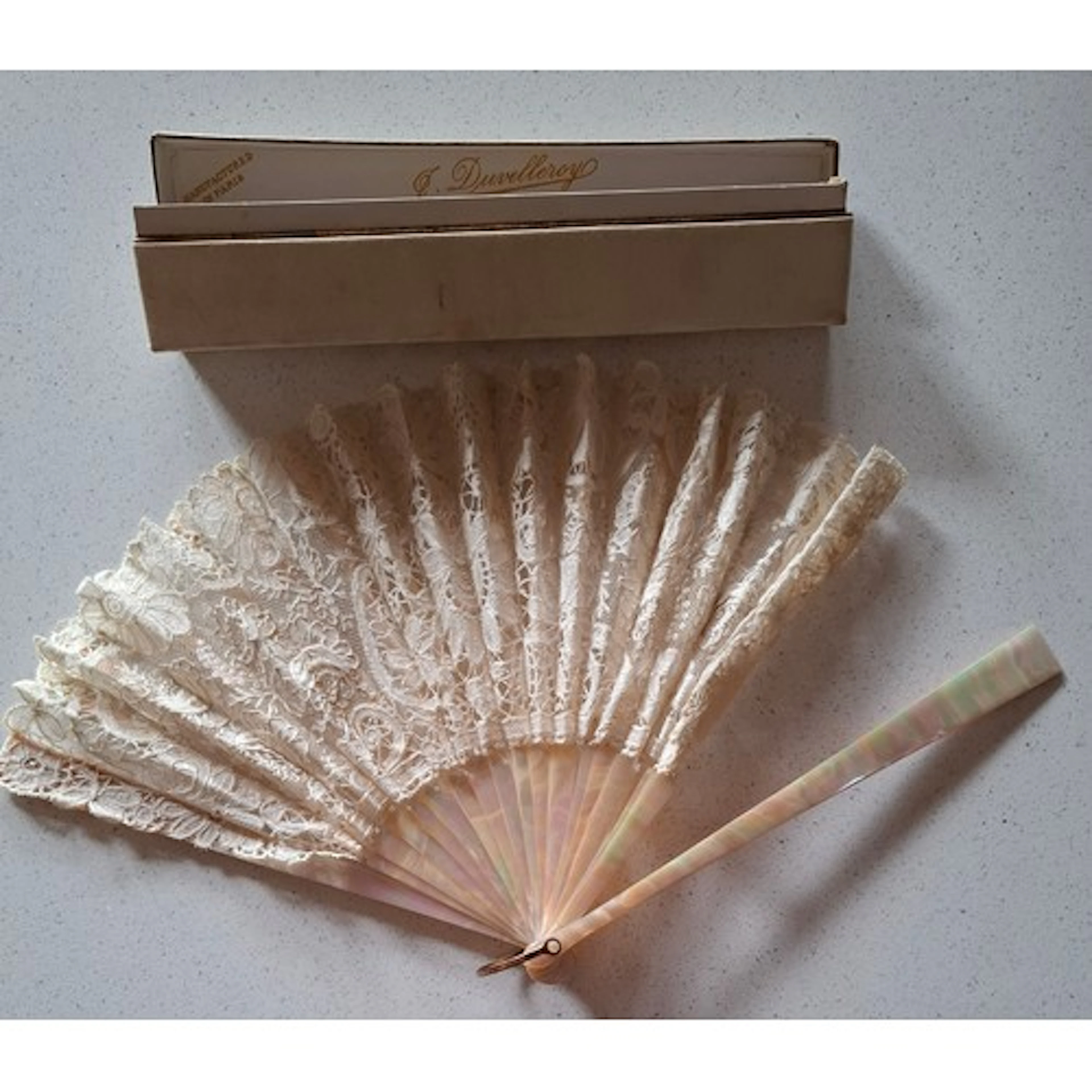 A mid 20th Century fan having pink pearlised wands and cream...