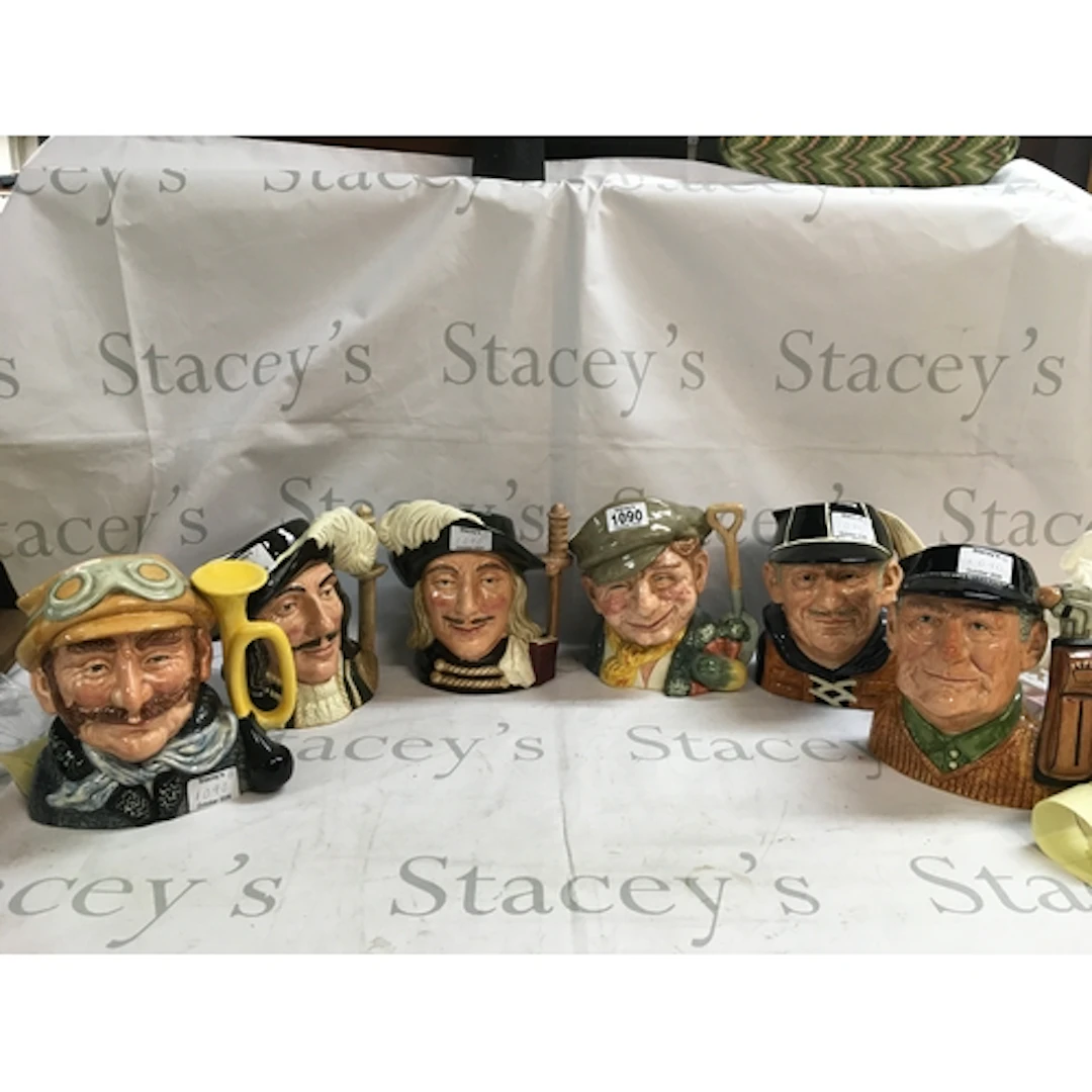 A collection of 6 Doulton character jugs including: the golf...