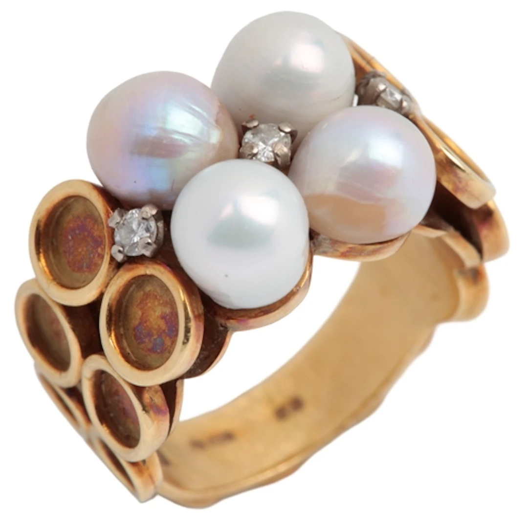 A gold, pearl and diamond ring, circa 1975, the ring set wit...