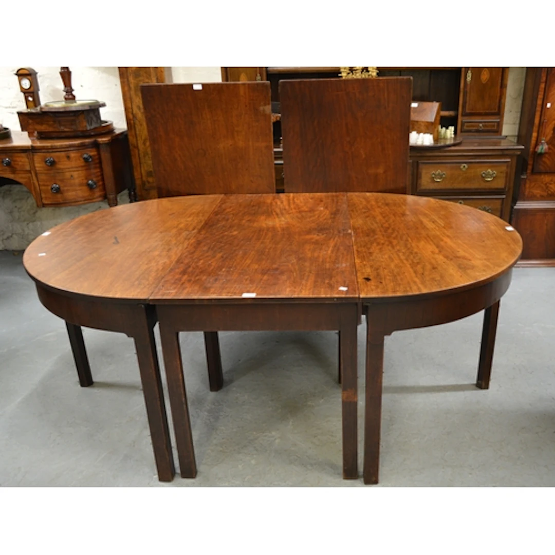 George III mahogany three section D-end dining table, the pl...