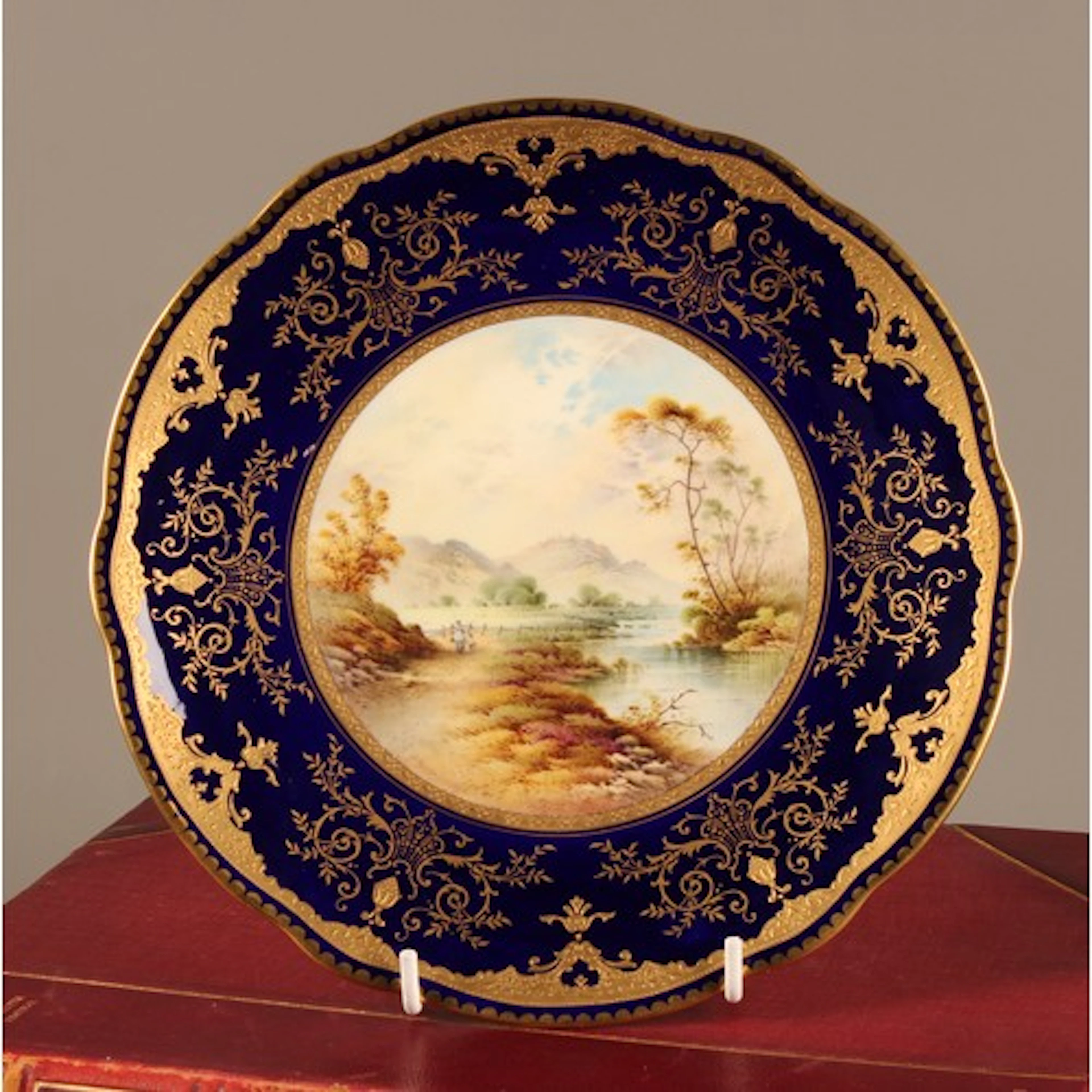 A Coalport named view shaped circular plate, painted by P. S...