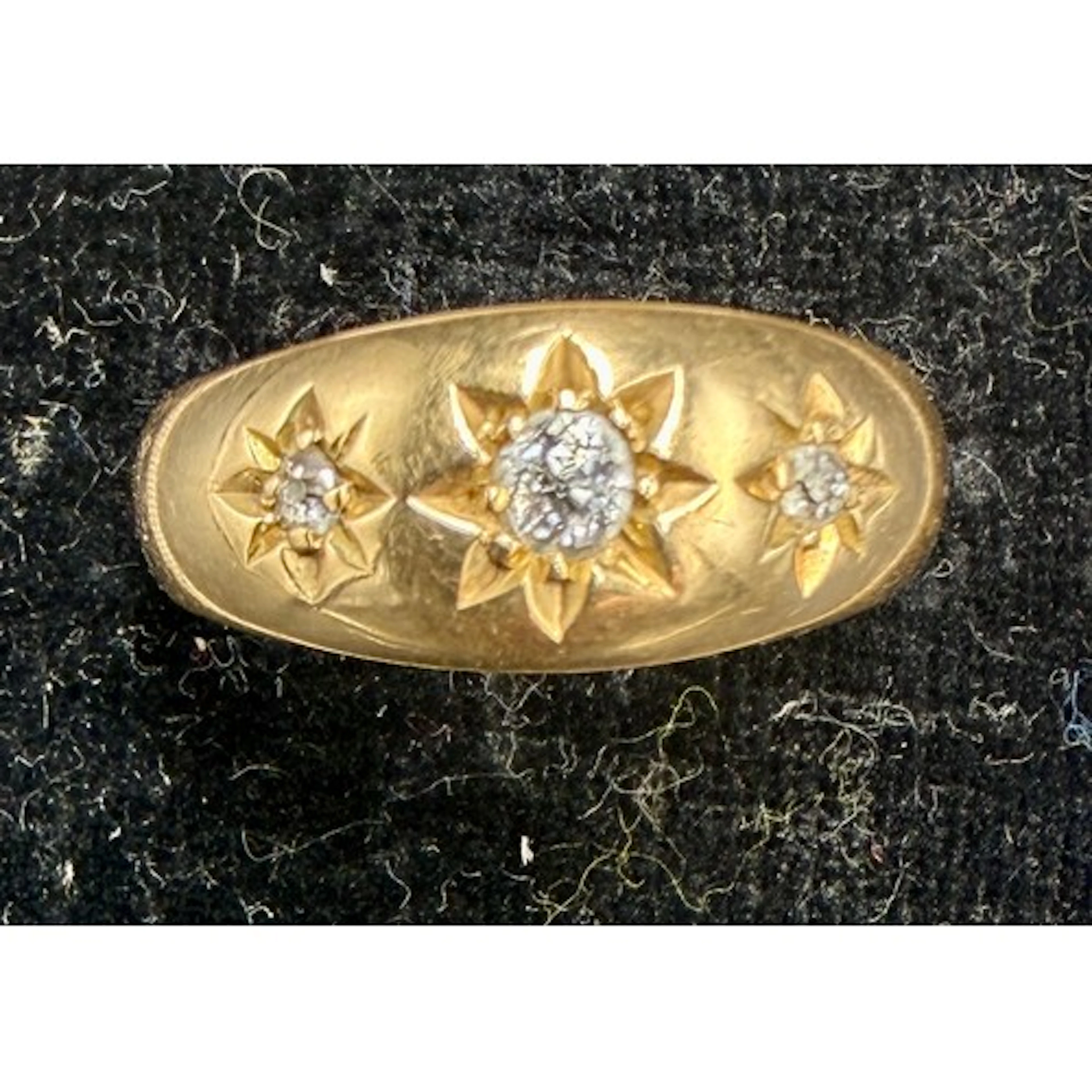 An 18 carat gold ring set with three diamonds. Size M/N. Wei...