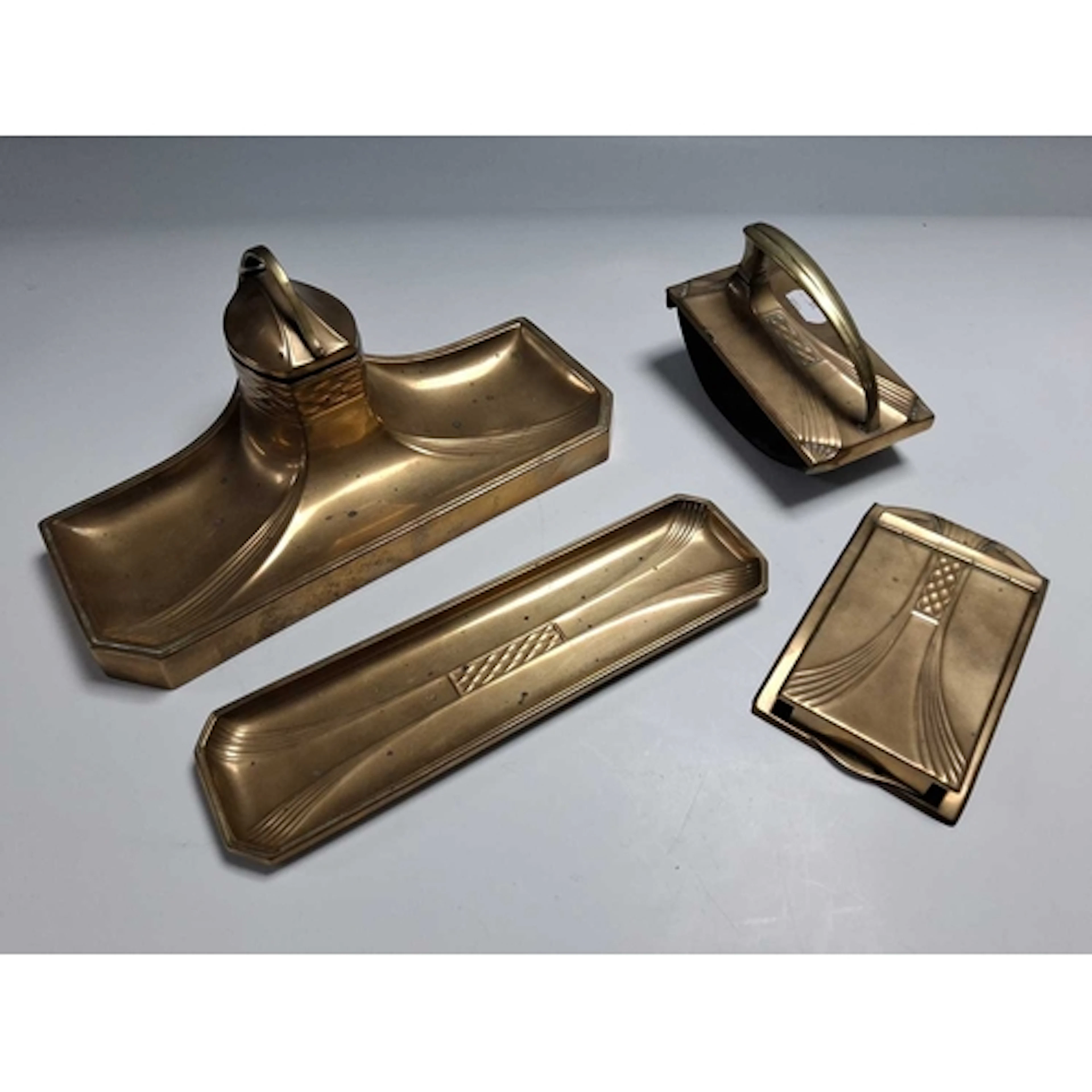 A WMF BRASS DESK SET, comprising a deskstand of sweeping for...