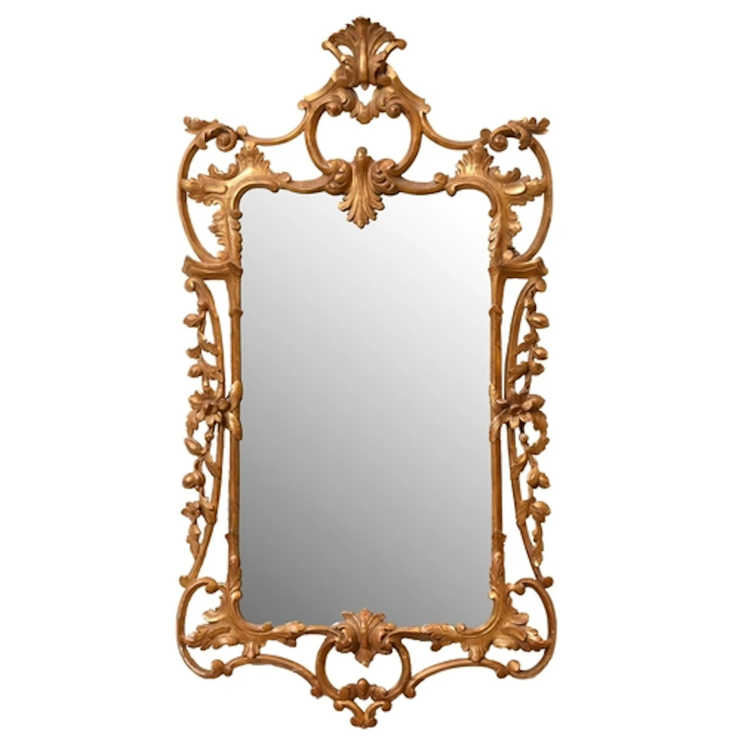 A George III rococo giltwood mirror, carved with C-scrolls a...