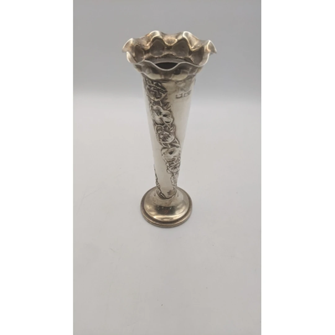 A vintage weighted silver vase having a flared rim with a fl...