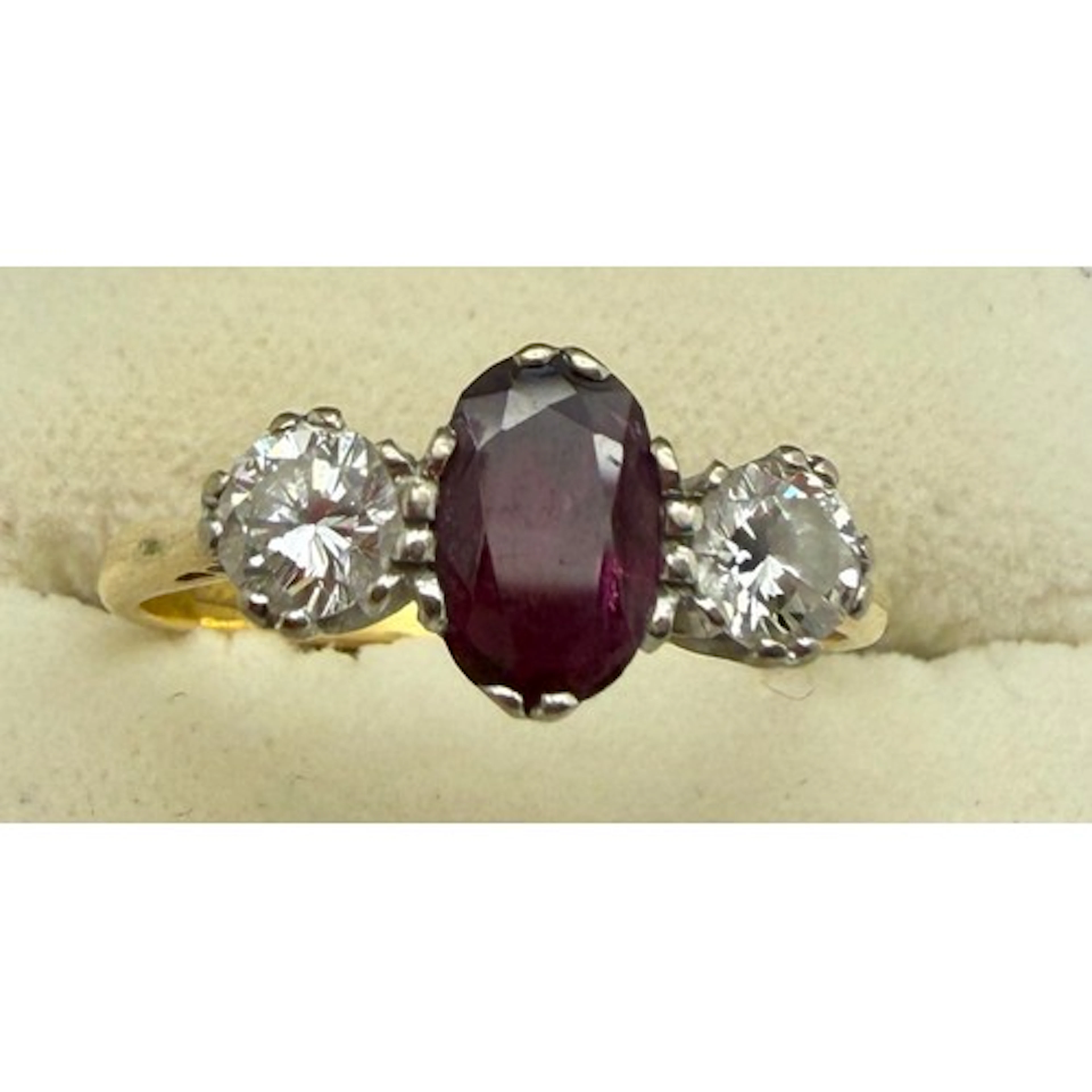A three stone ruby and diamond ring set in 18 carat yellow g...