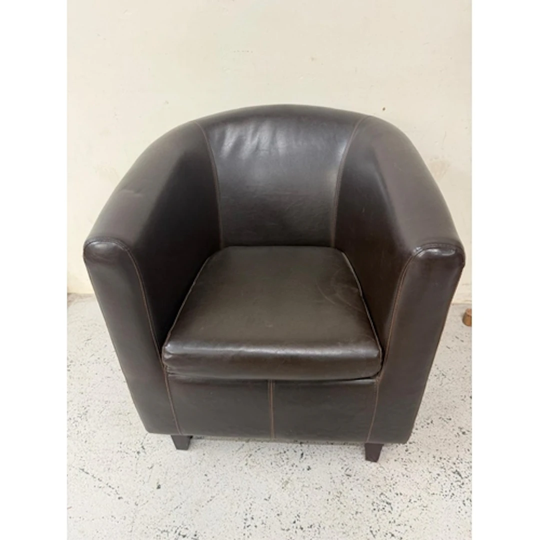 A brown faux leather tub chair