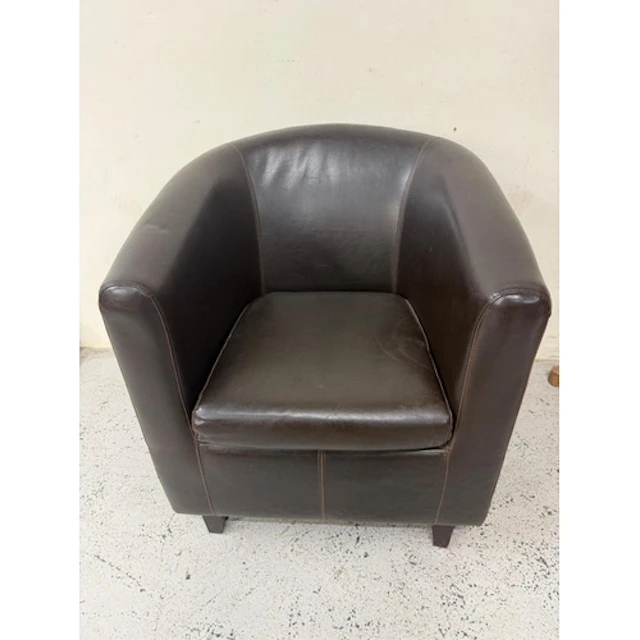 A brown faux leather tub chair