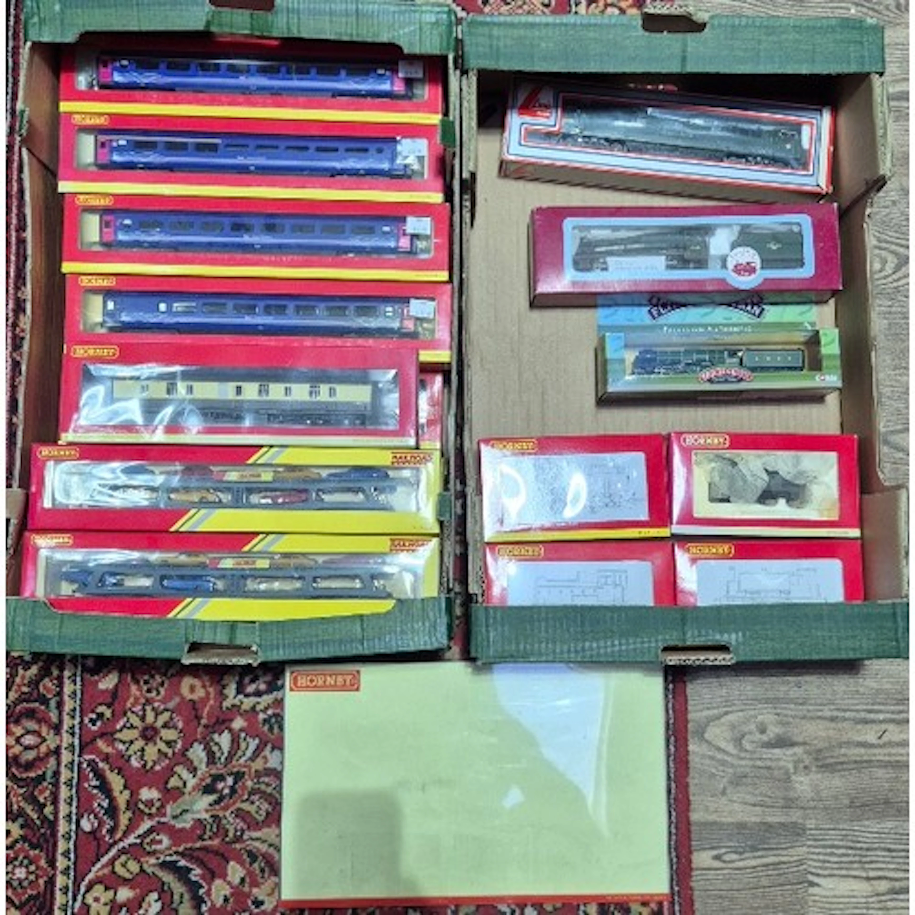 Two boxes of assorted model train items to include engines (...