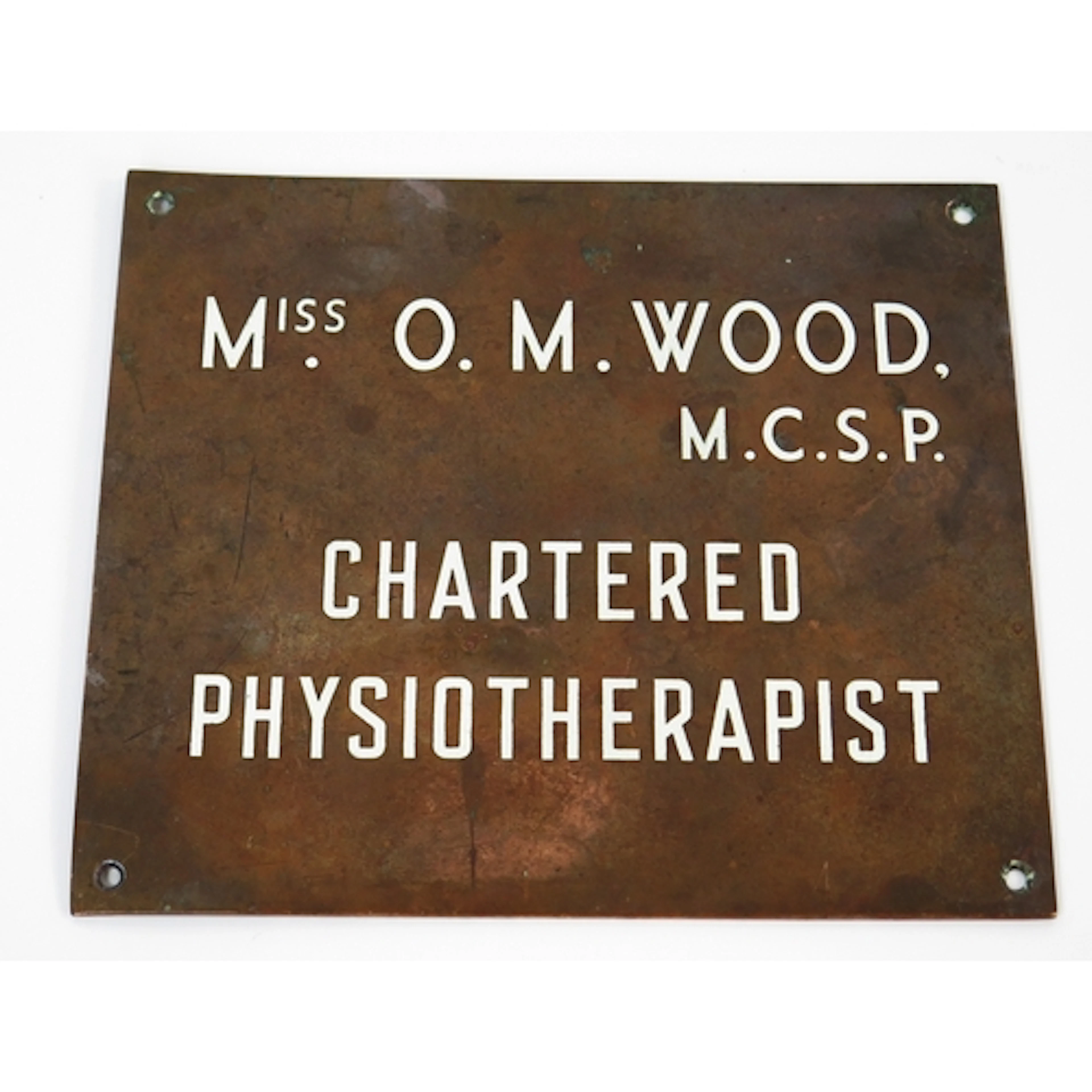 A bronze wall plaque "Miss O.M. Wood M.C.S.P. Chartered Phys...