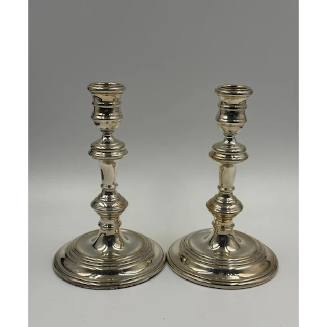 A pair of silver candlesticks, classic baluster shape with d...