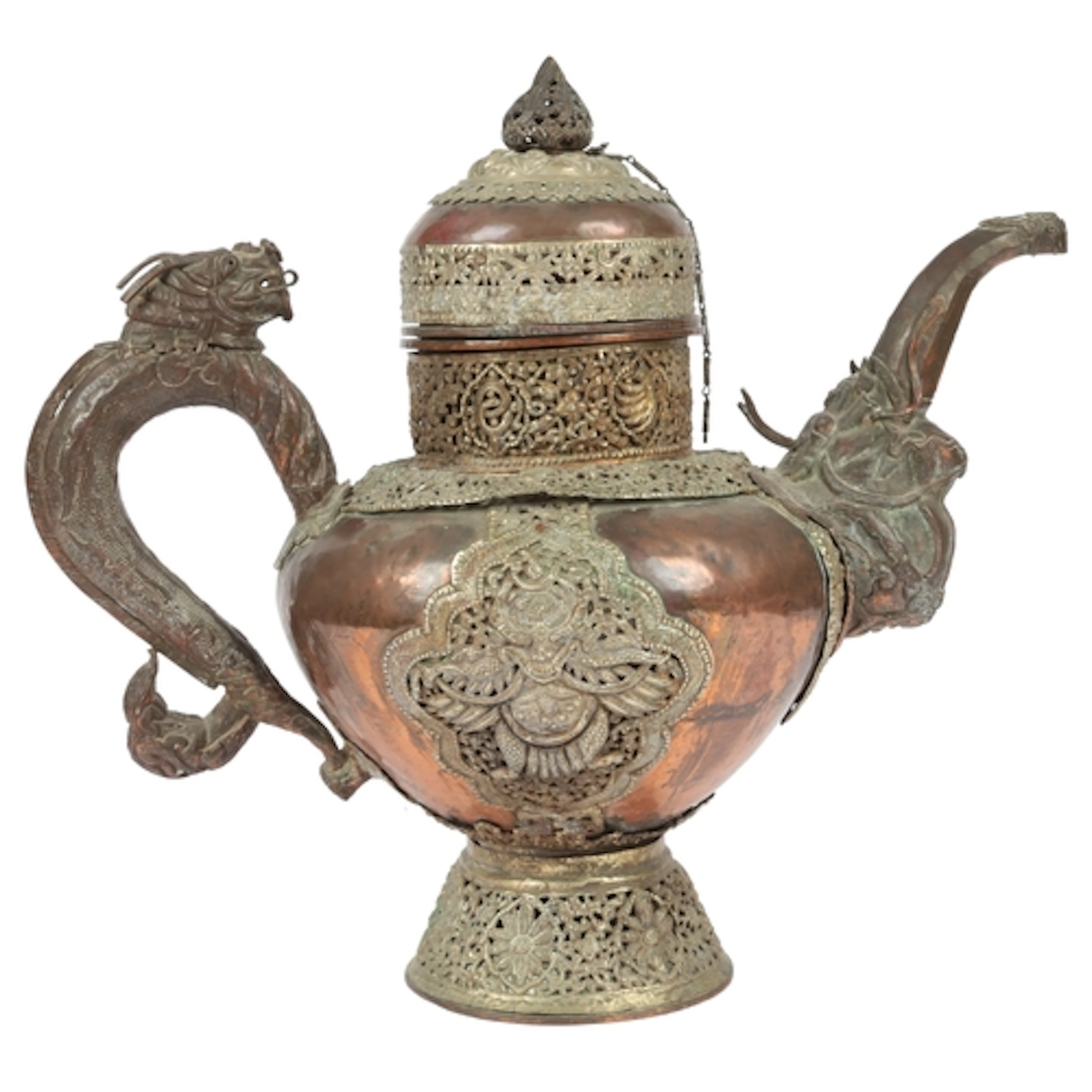 A large Tibetan white metal and copper repoussé teapot, late...