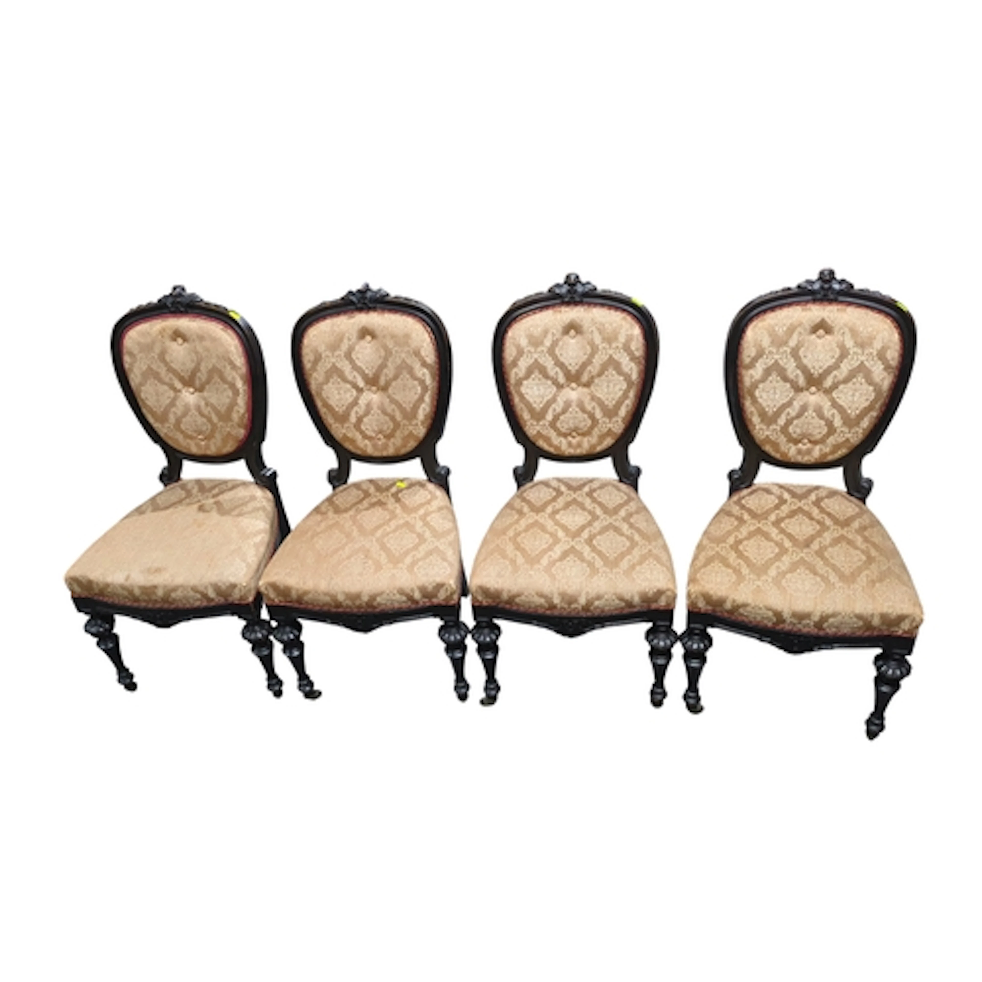 A set of four Victorian ebonised dining chairs, each with a ...