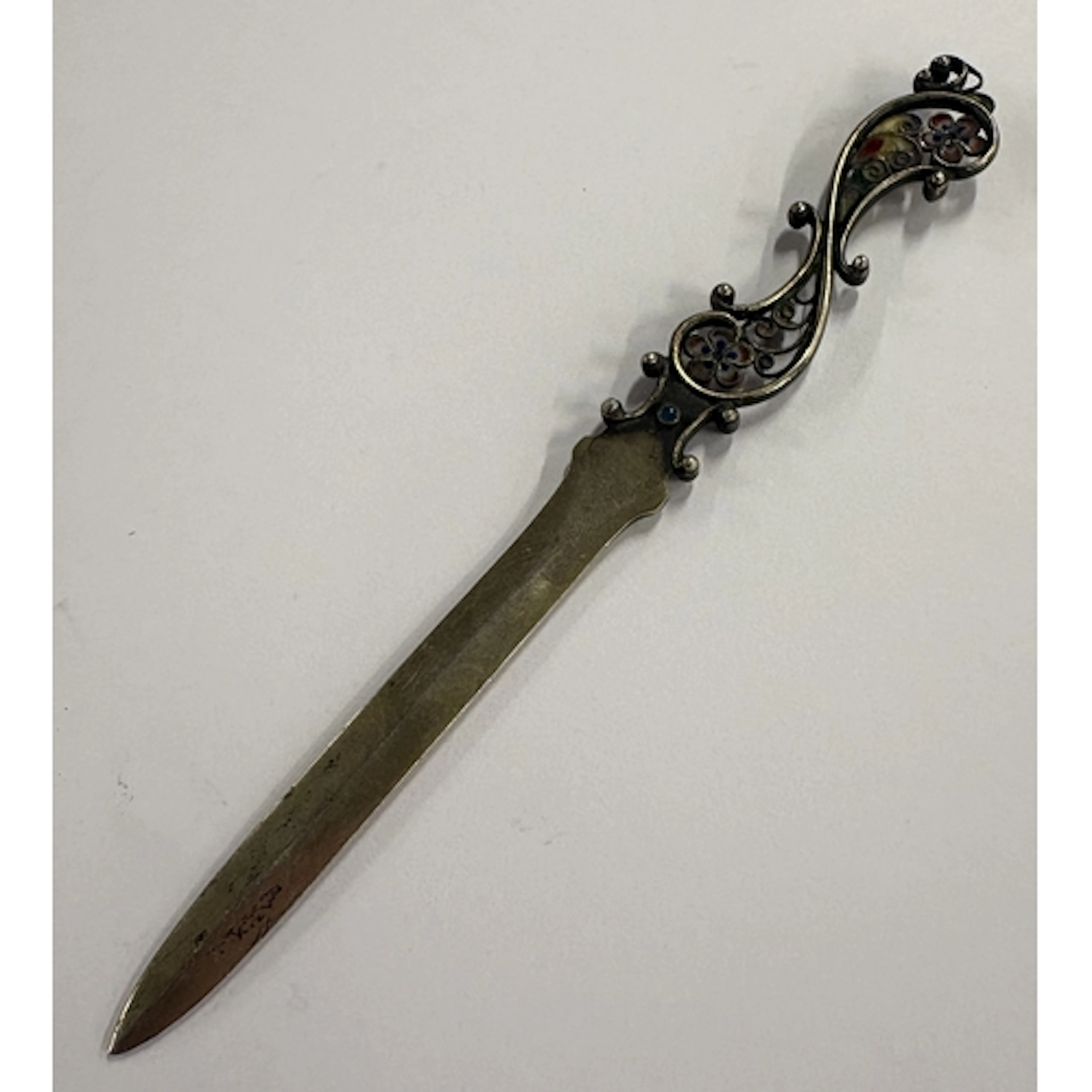 A silver letter opener with plique-à-jour decoration. Circa ...