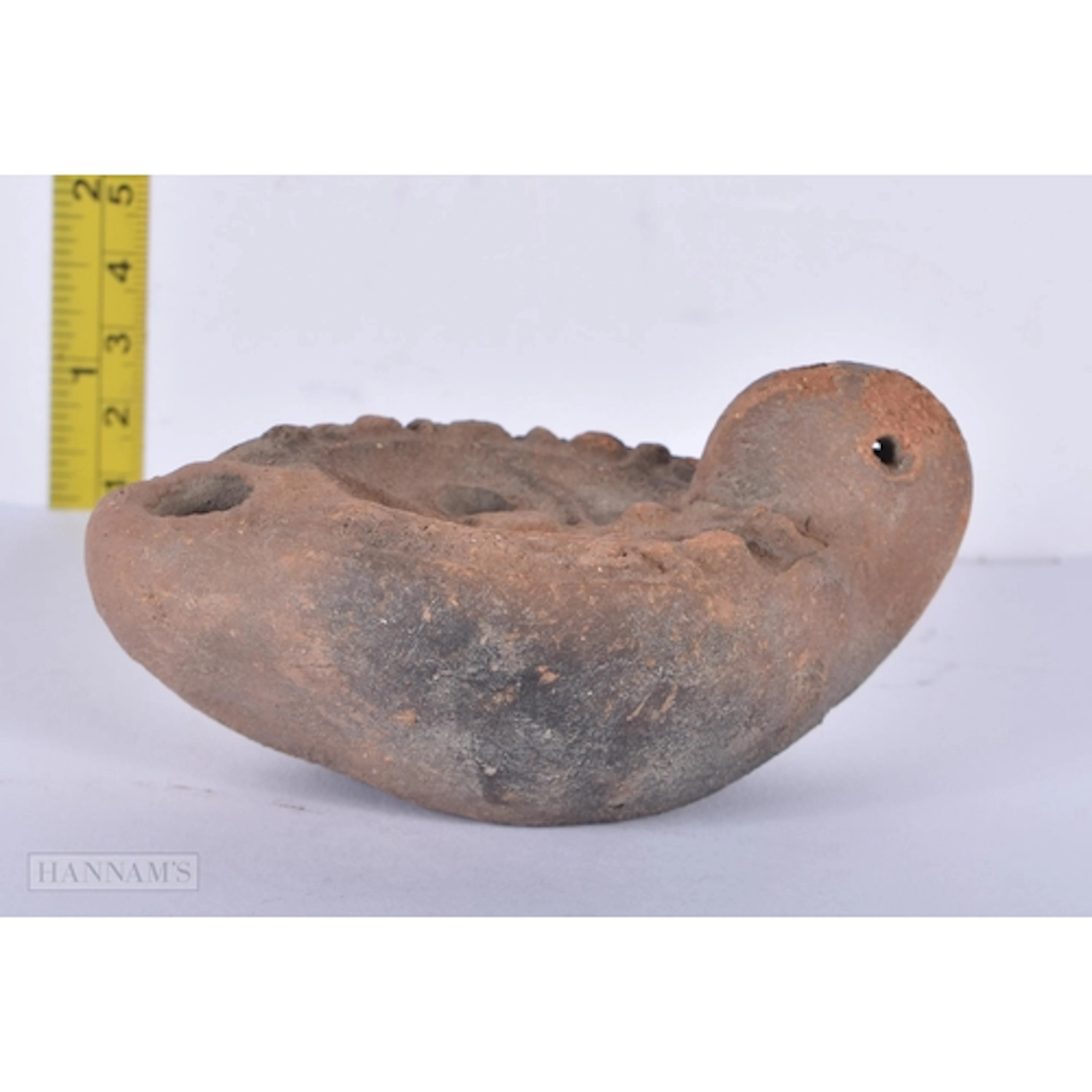 A Roman terracotta oil lamp 4.5 x 10cm