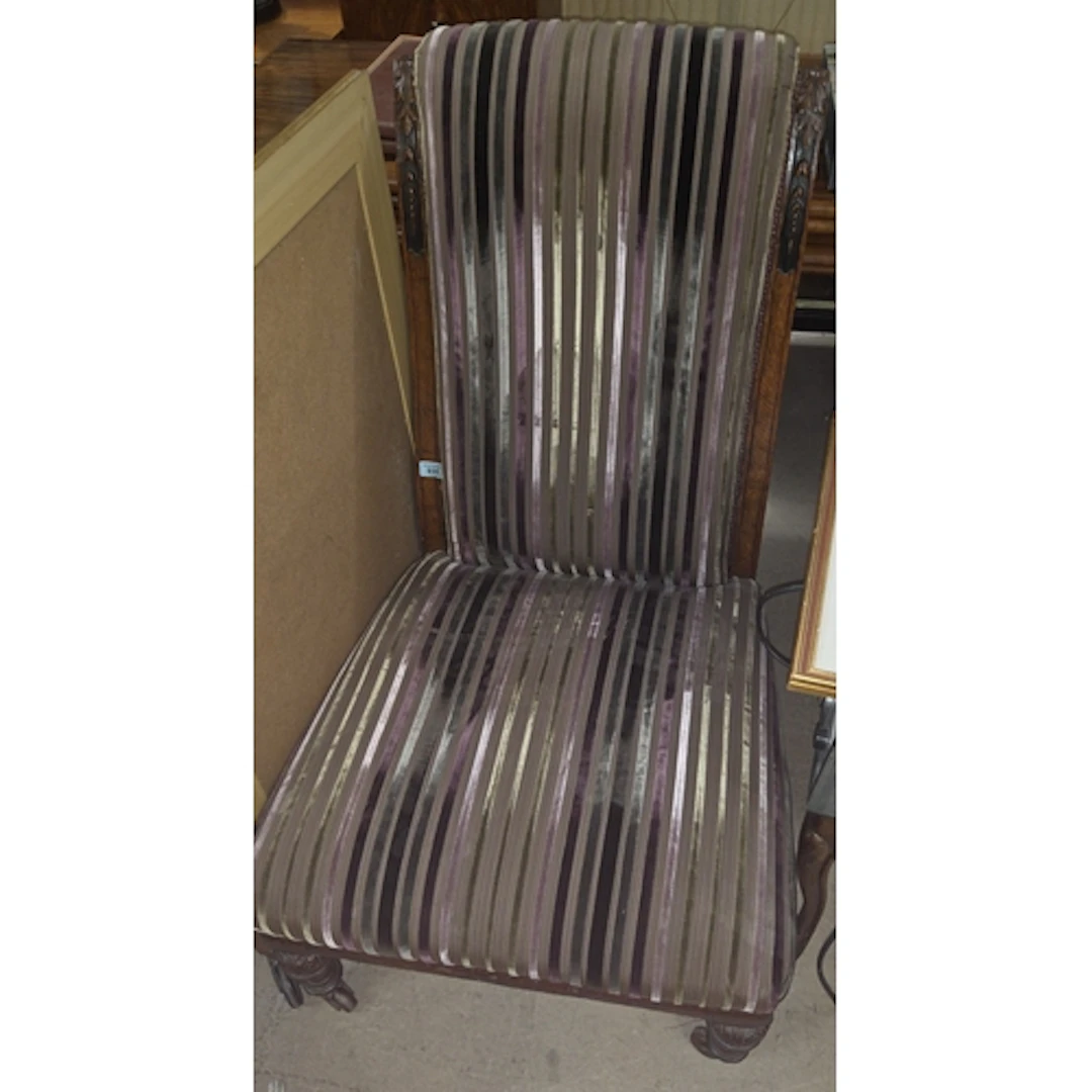 A late 19th/early 20th century oak slipper chair with carved...
