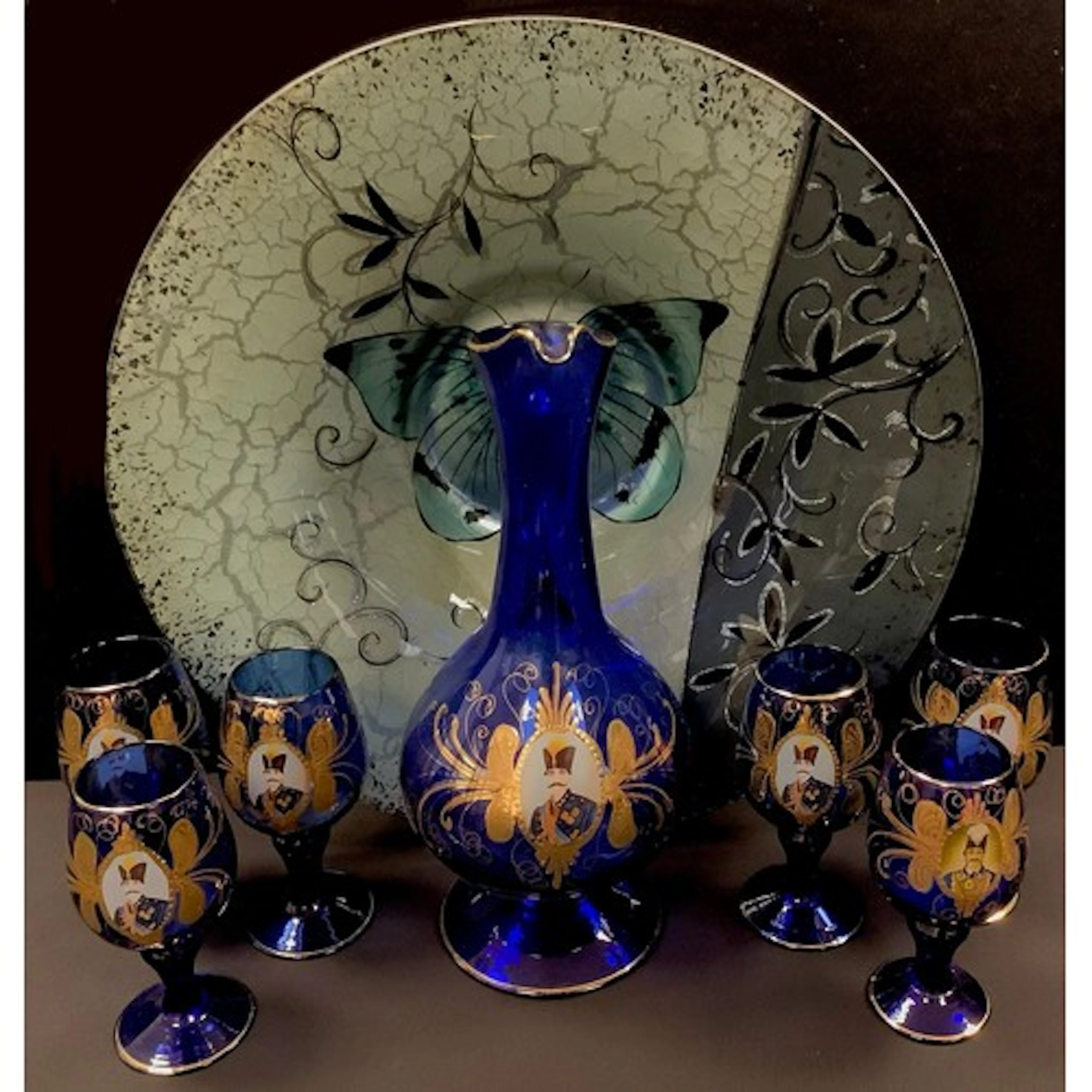 A Russian blue glass wine jug and glasses, printed with an E...